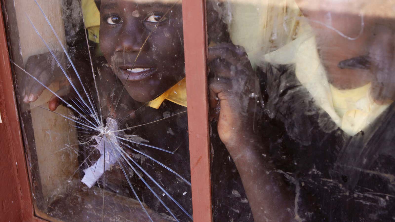 In this photo taken Monday June 11, 2012, a child looks through the window of her classroom at a school near Thohoyandou, South Africa. Leaders…