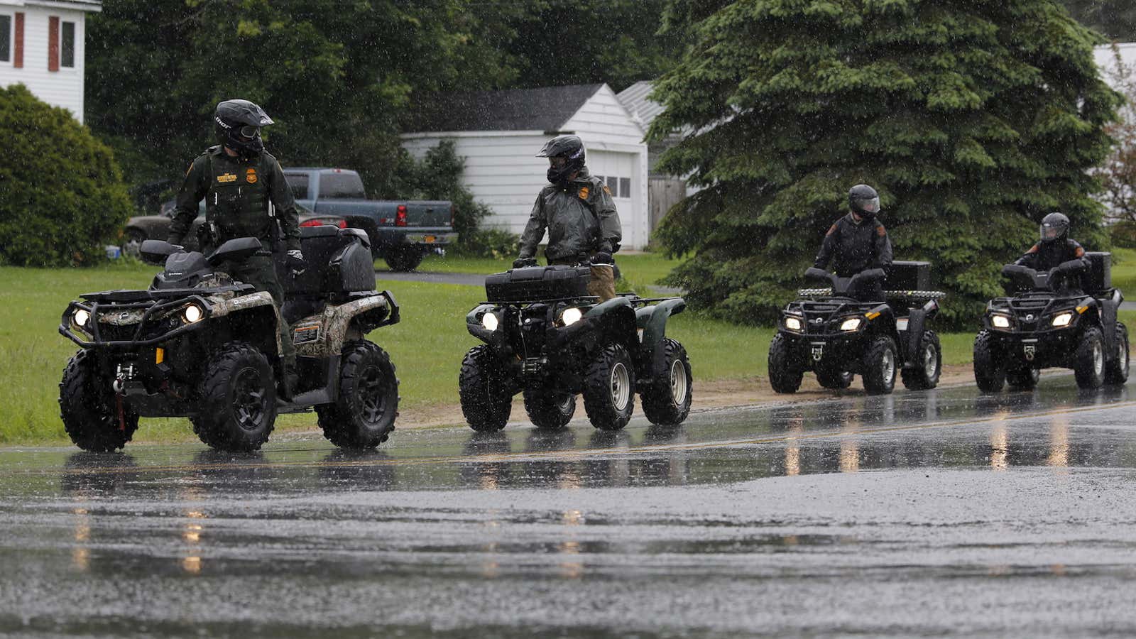 Law enforcement agents search for two recently-escaped prisoners near Cadyville, New York.