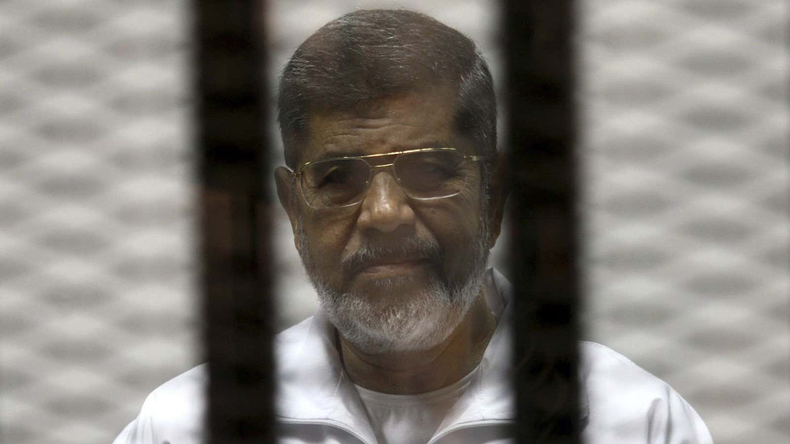 Ousted Egyptian president Mohamed Morsi behind bars during trial in Cairo this month.