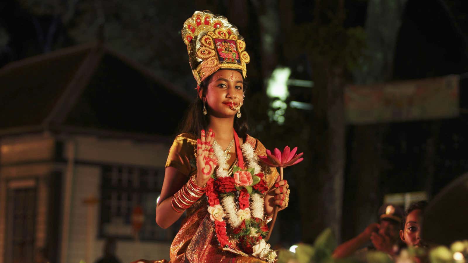 A girl dressed as Lakshmi, the Hindu goddess of wealth.