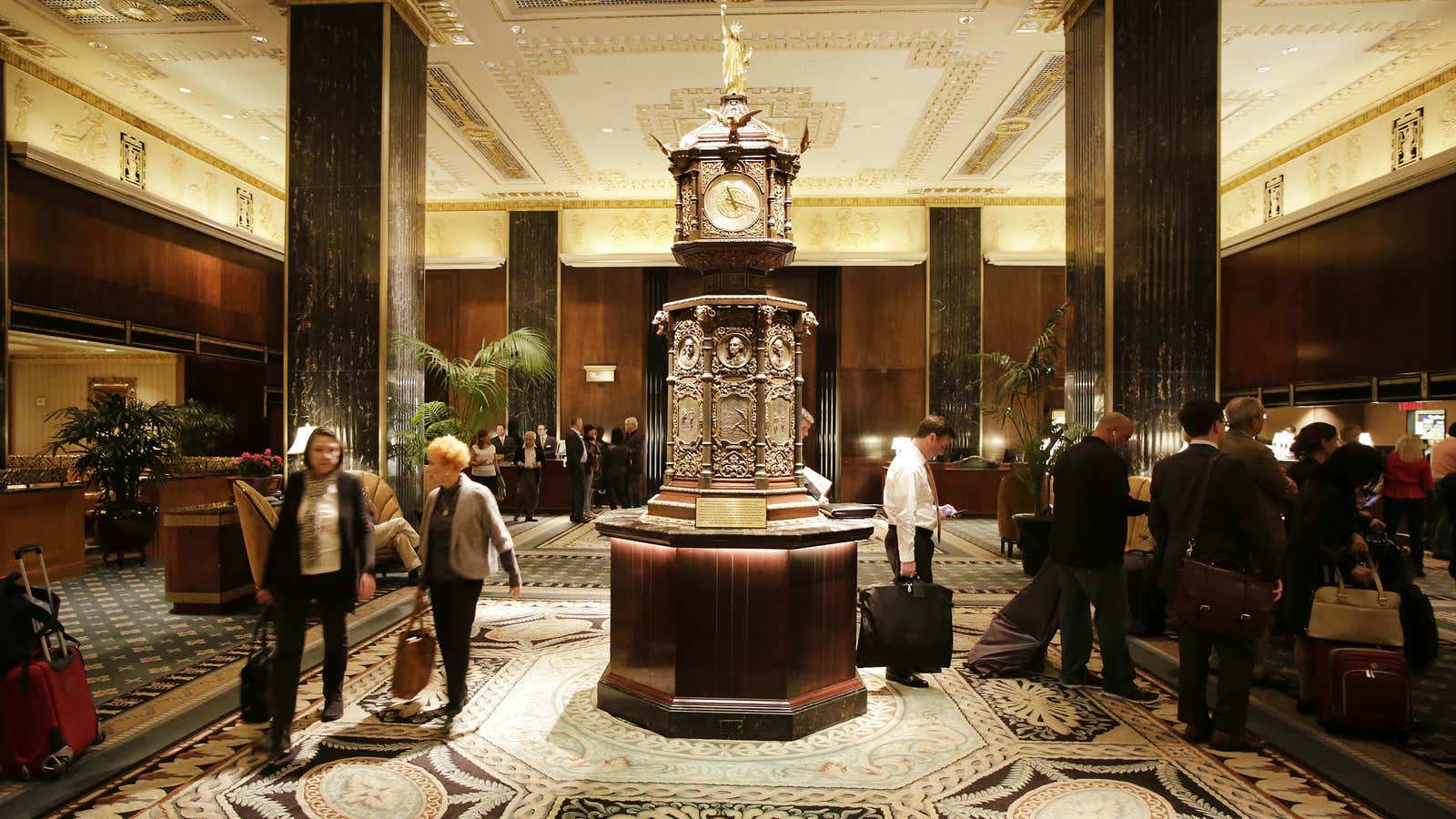 The famous clock, topped by a miniature Statue of Liberty, greets guests.