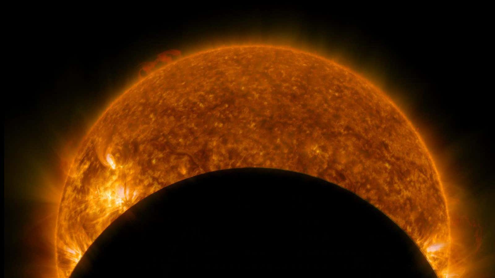 NASA’s Solar Dynamics Observatory captured this ultraviolet image of the moon eclipsing the sun on Jan. 31, 2014.