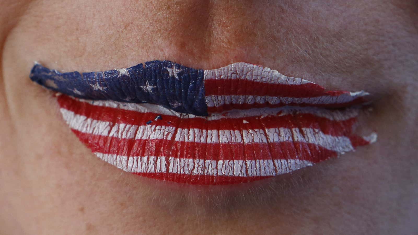 A fan of the U.S. is seen with lips painted in the colours of their national flag at the men’s skeleton event during the 2014…