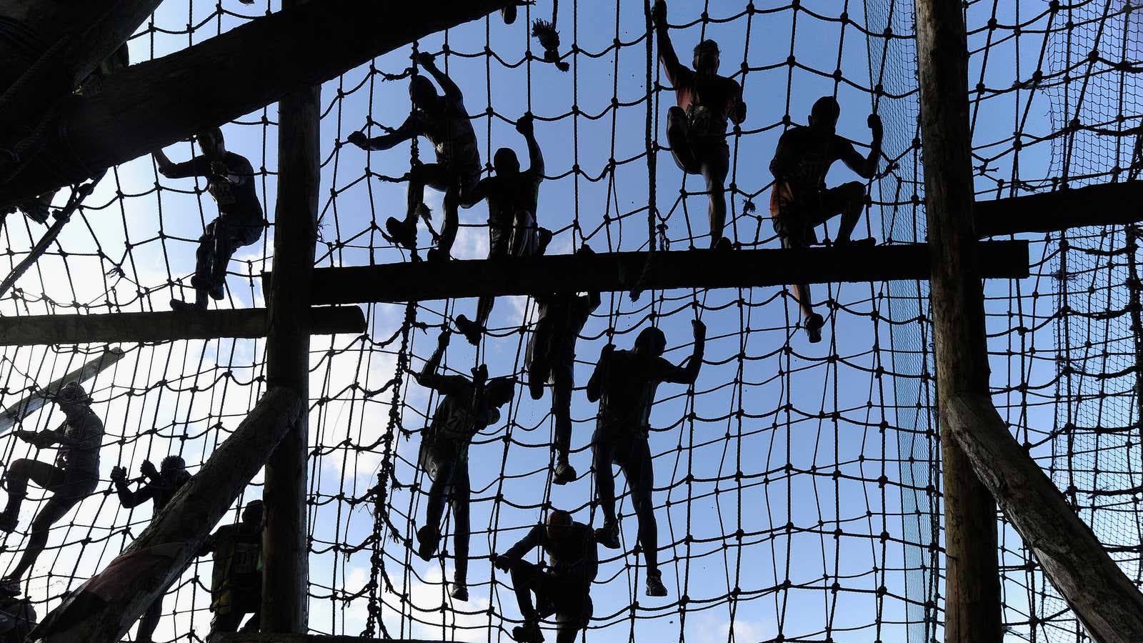 Competitors climb nets during the Tough Guy event in Perton, central England, January 27, 2013. The annual event to raise cash for charity challenges thousands…