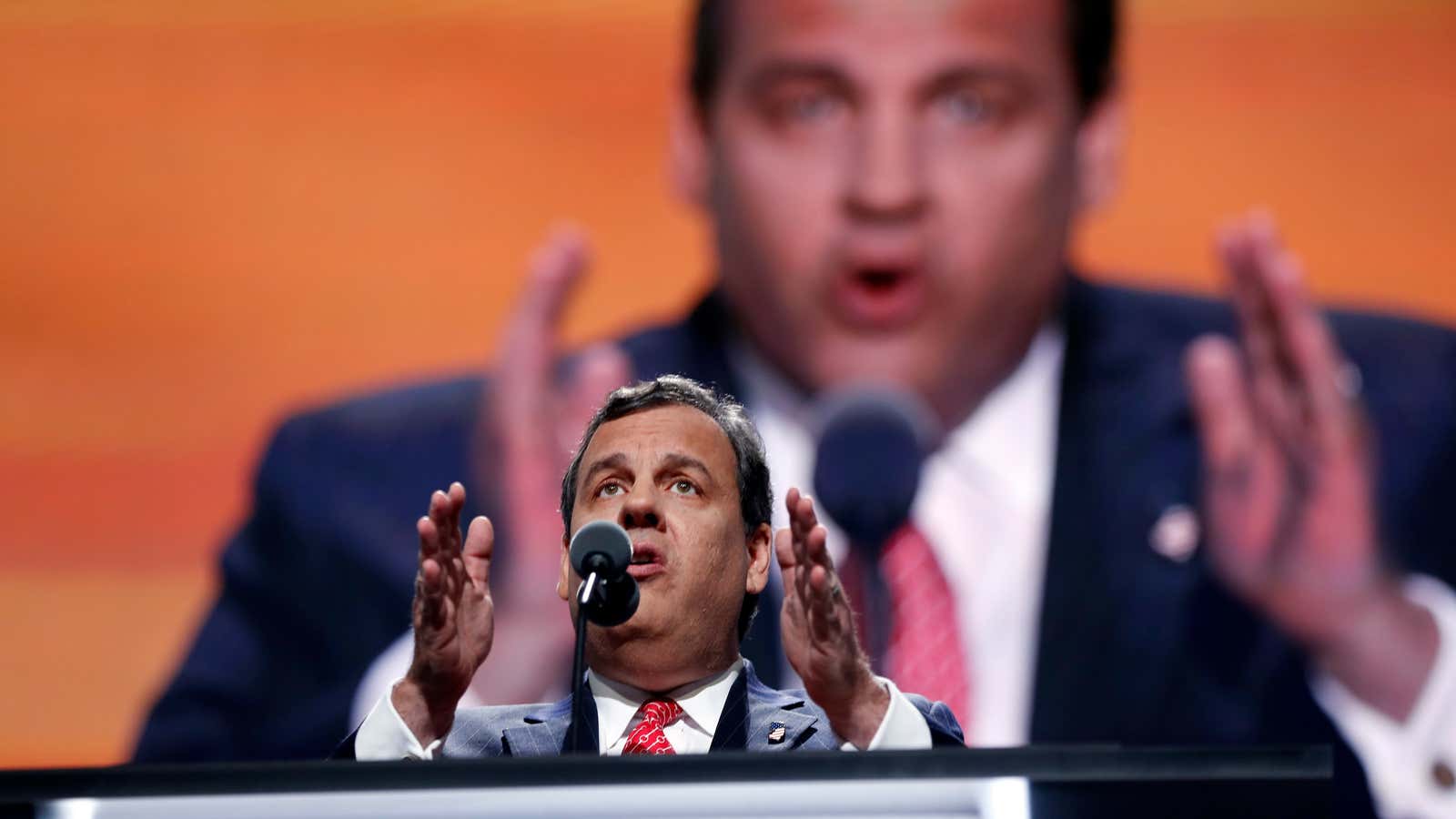 New Jersey governor Chris Christie “prosecutes” Hillary Clinton, in absentia, for crimes against the world.