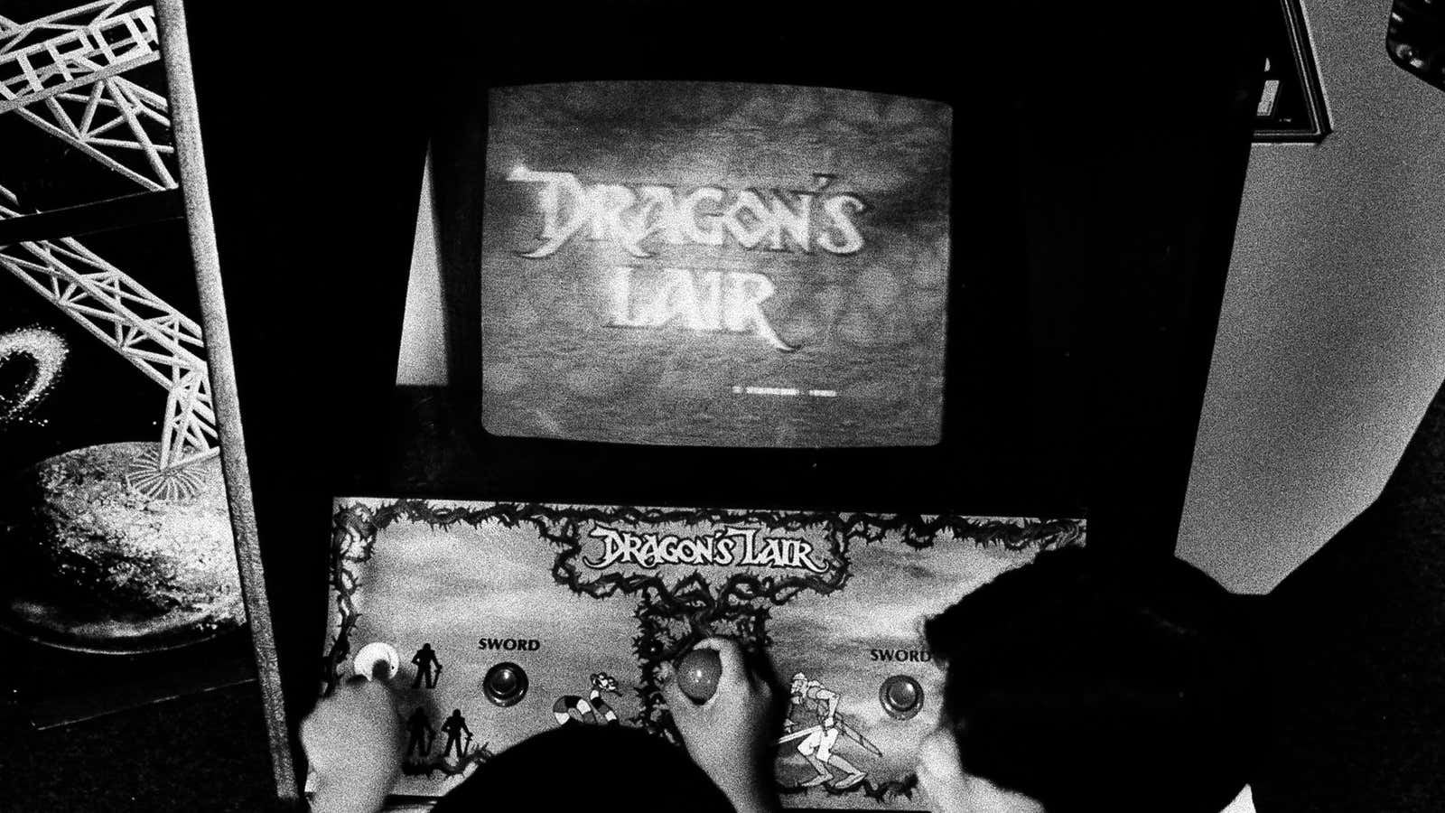 FILE- In this July 29, 1983, file photo Ben Ho plays “Dragon’s Lair”, a new video game at Captain Video arcade in West Los Angeles.…