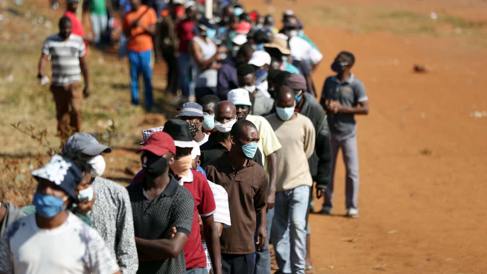 South Africans waiting in a queue to receive food aid near Laudium suburb in Pretoria, South Africa, May 20, 2020.