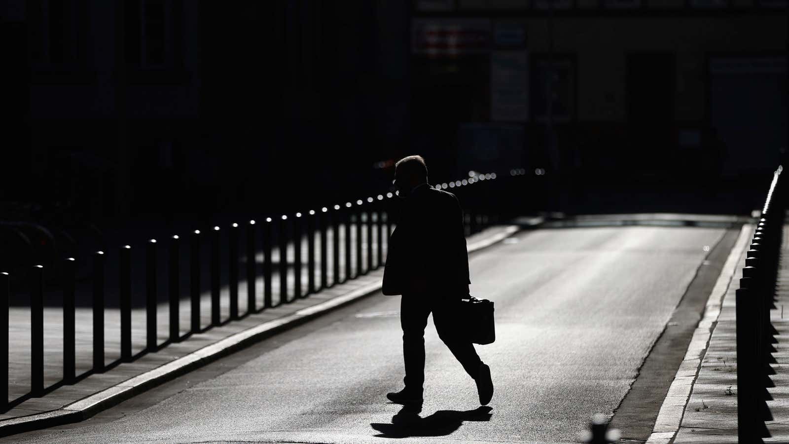 A businessman crosses a street as the spread of the coronavirus disease (COVID-19) continues in Frankfurt, Germany, September 8, 2020.