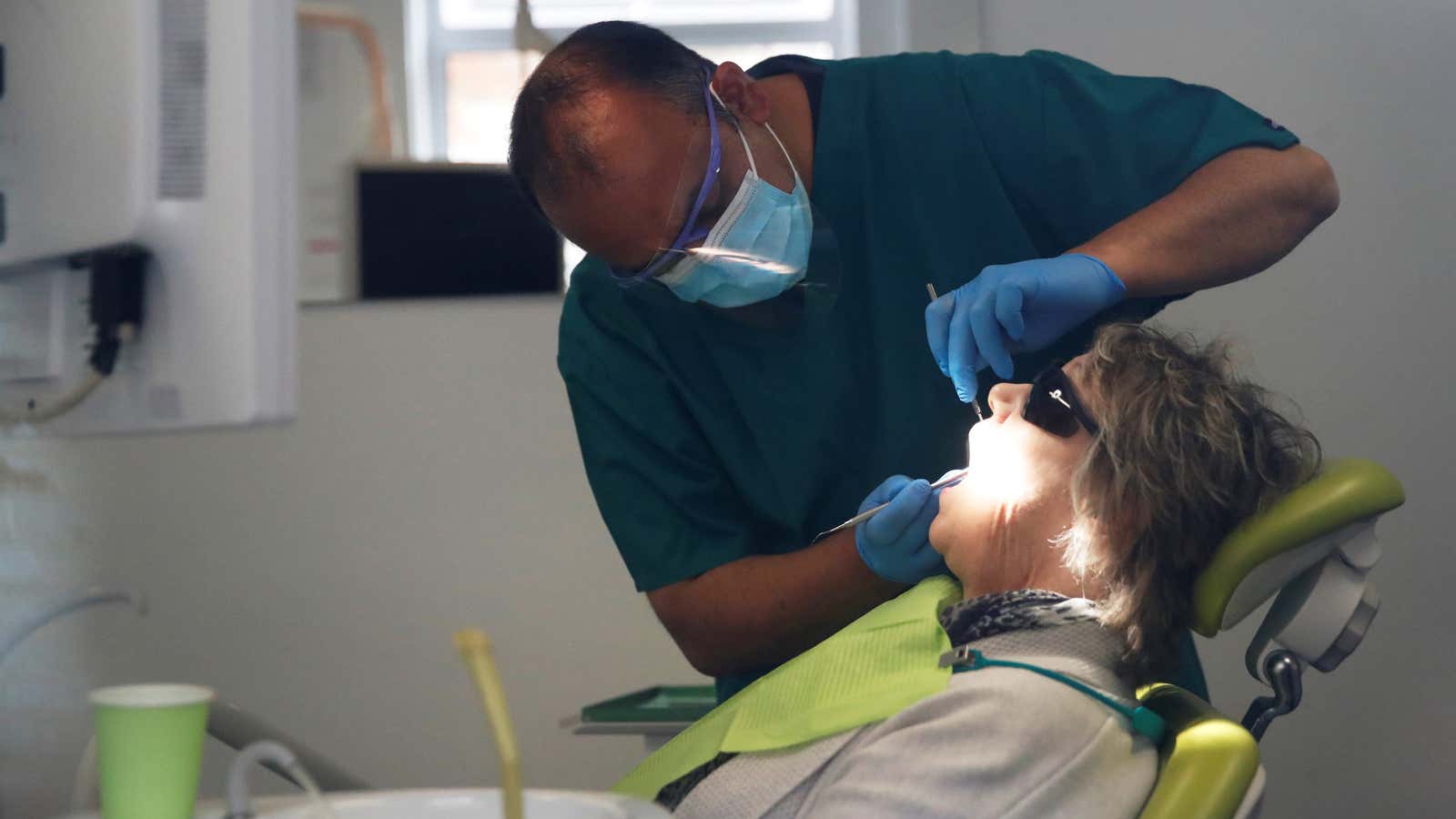A dentist tends to a patient in Milton Keynes, UK.
