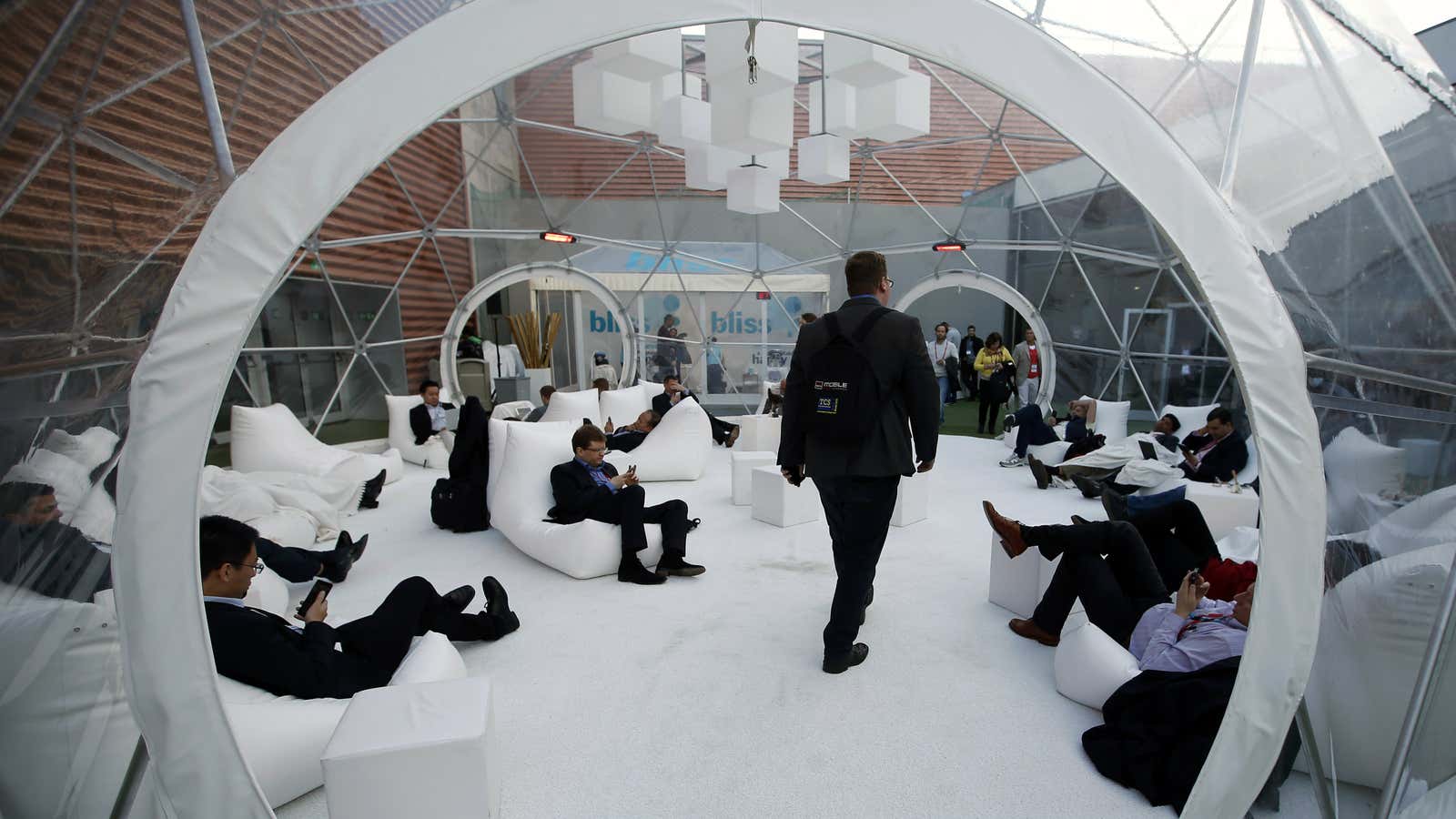 Visitors rest inside a bubble at the terrace during the Mobile World Congress in Barcelona, February 26, 2014. REUTERS/Albert Gea (SPAIN – Tags: BUSINESS TELECOMS…