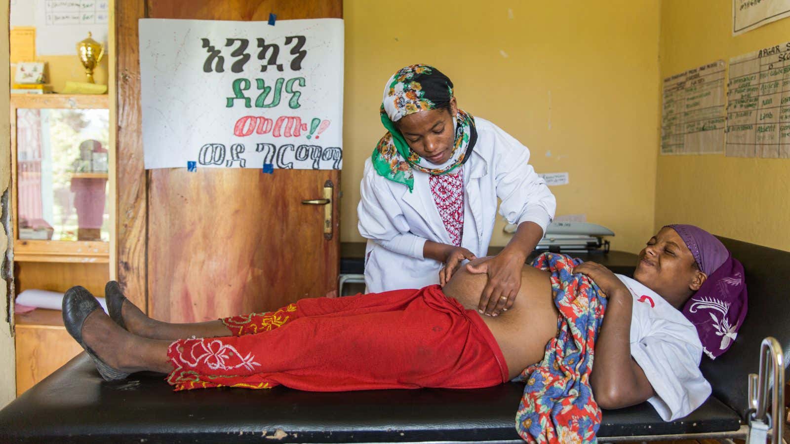 Mehbuba Shemsie 24, a mother of one and eight months pregnant, has the health of her fetus checked by a health extension worker.