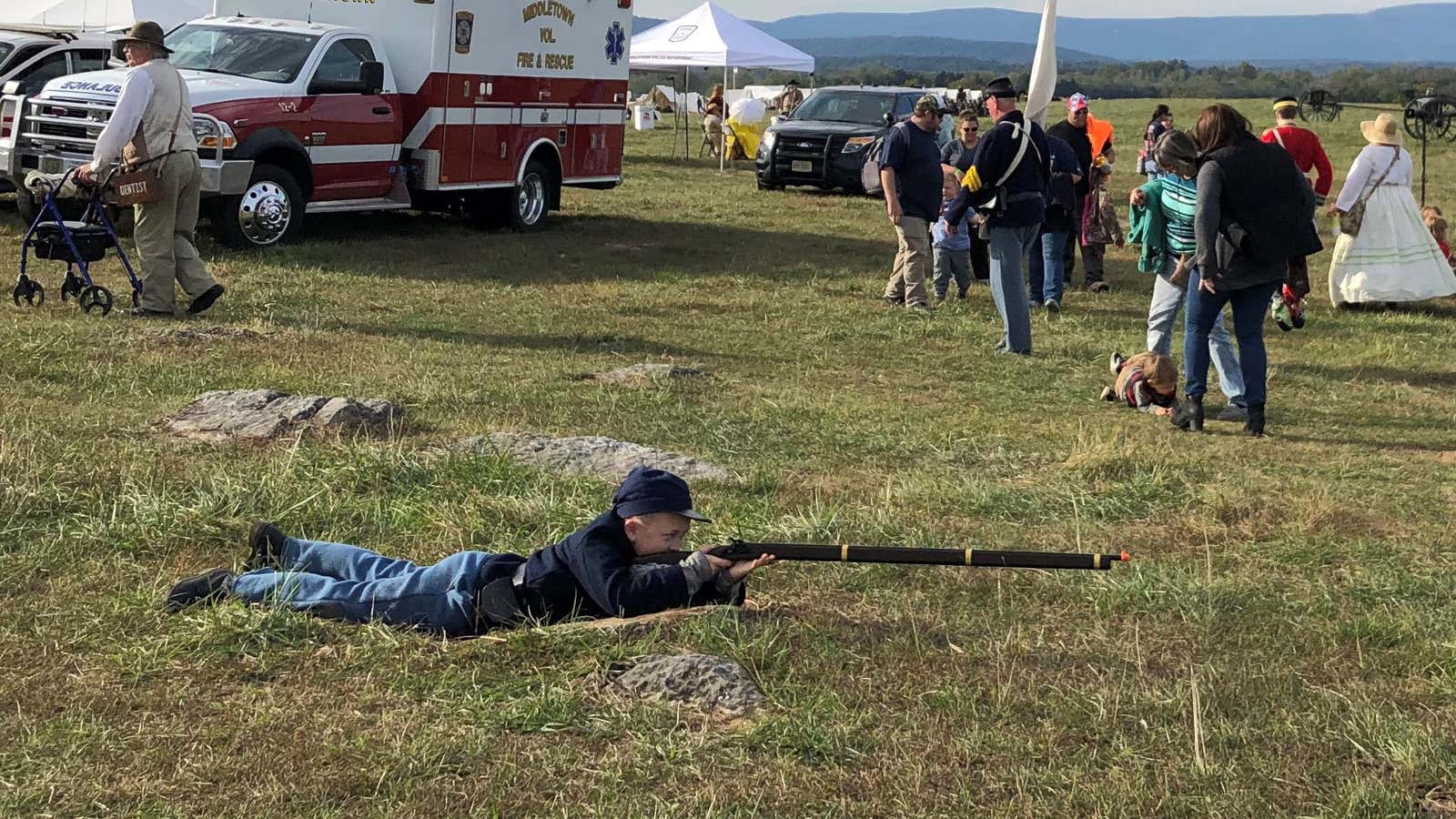 A child takes aim at the 2019 reenactment of the Battle of Cedar Creek, after the previous two were canceled due to bomb threats.