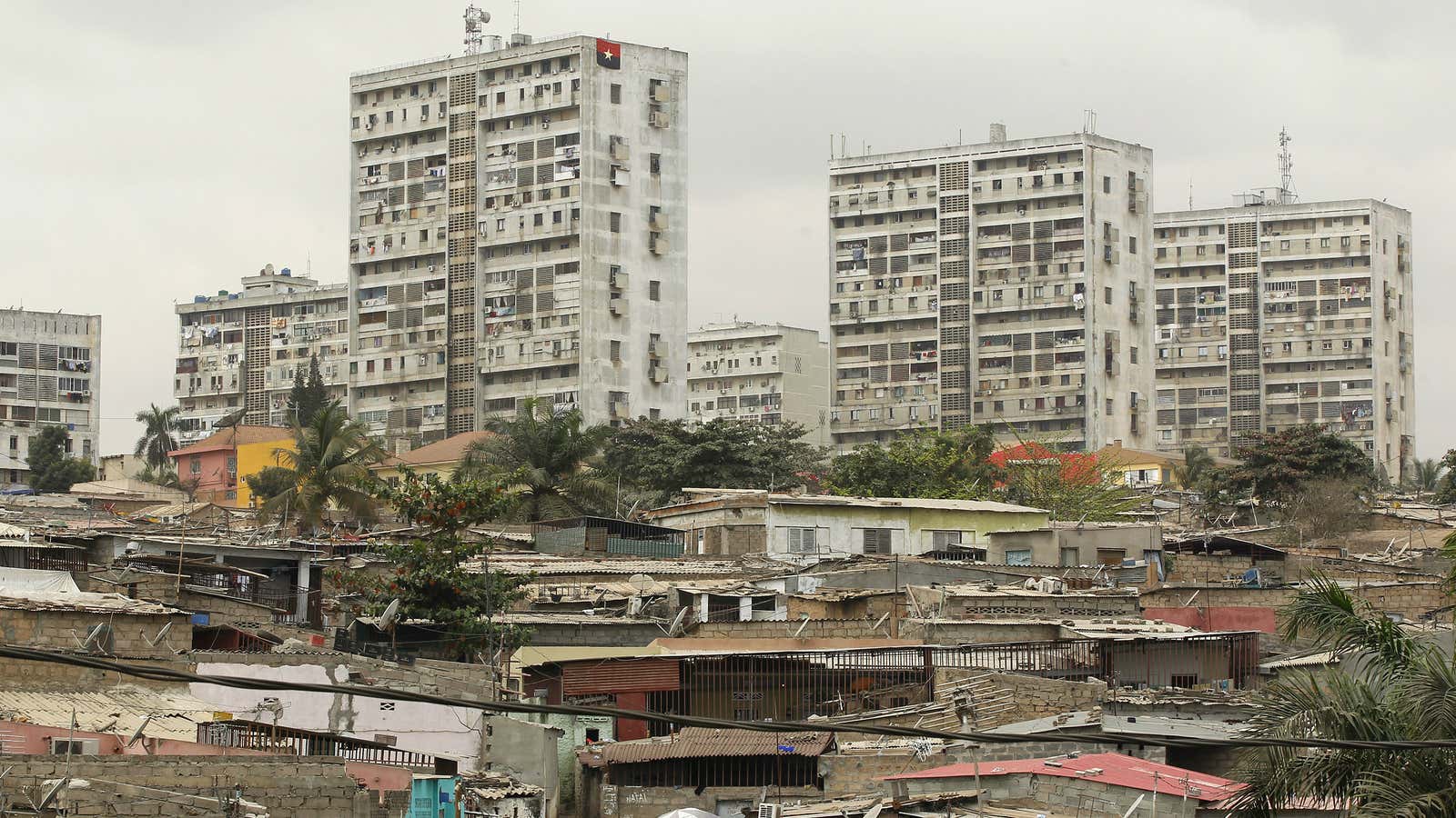 HIgh rise buildings in Luanda loom over poorer informal settlements.