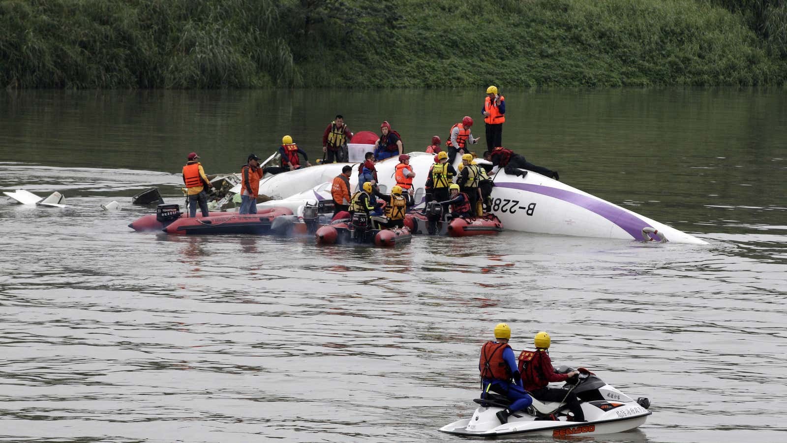 Emergeny responders carry out a rescue operation after a TransAsia Airways plane crash landed in a river near Taipei.