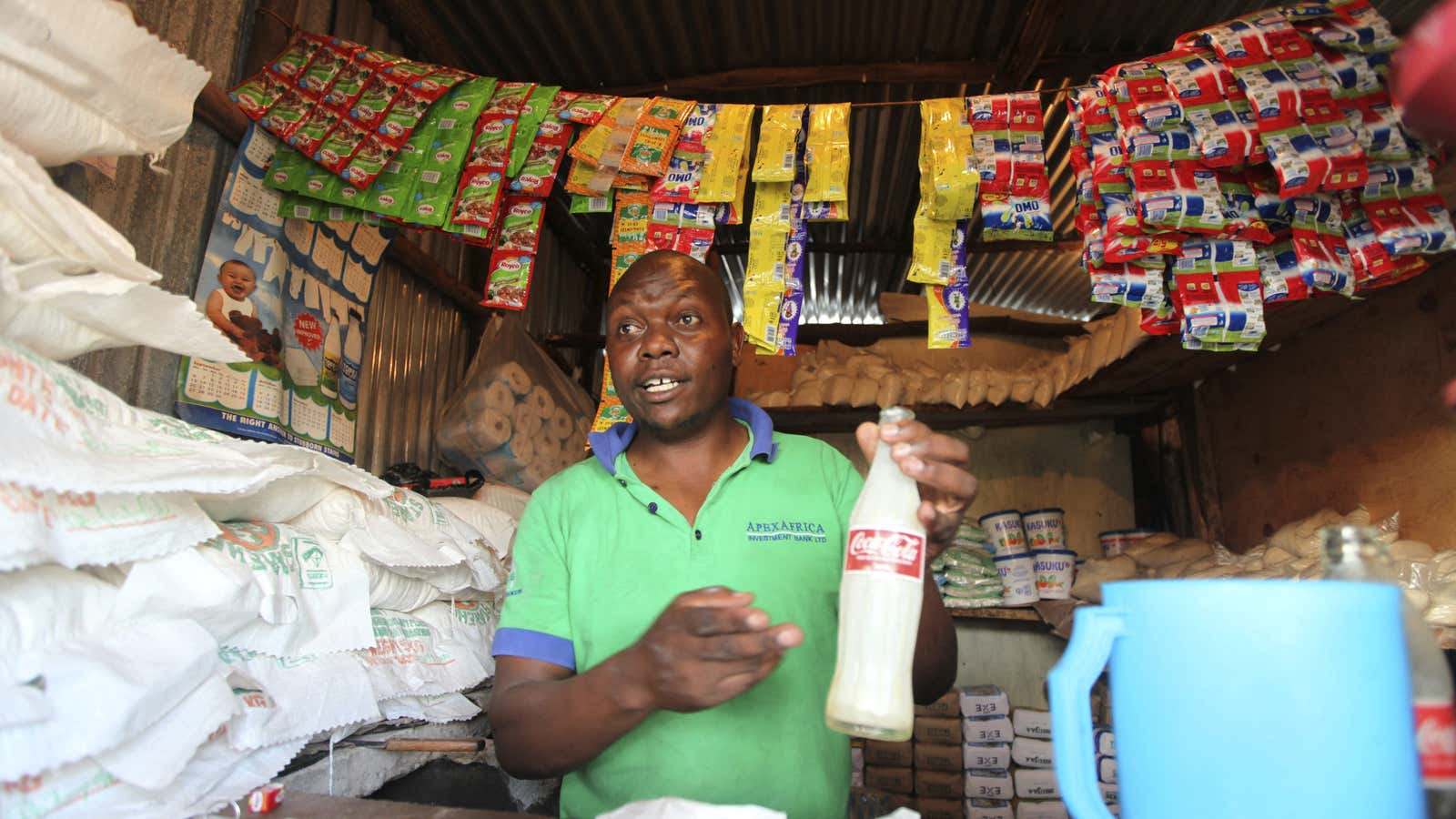 A shopkeeper prepares to serve a customer at his store in the sprawling Kibera slums in Kenya’s capital Nairobi