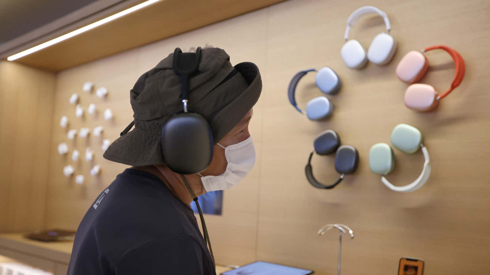A customer samples headphones at an Apple Store in Los Angeles.