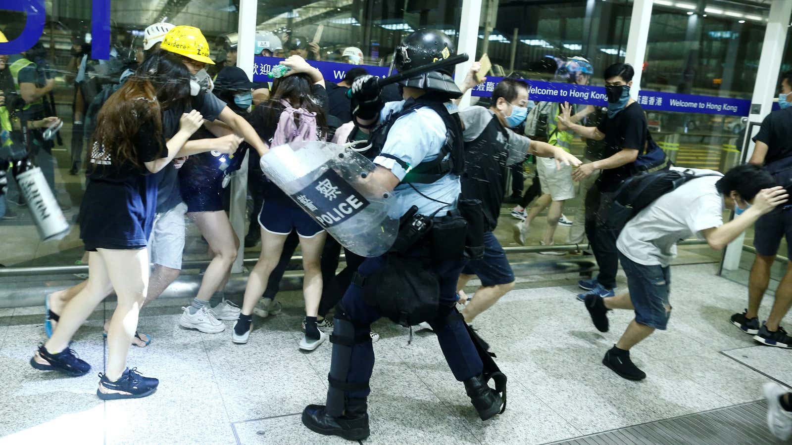 Police clash with anti-government protesters at the airport in Hong Kong.