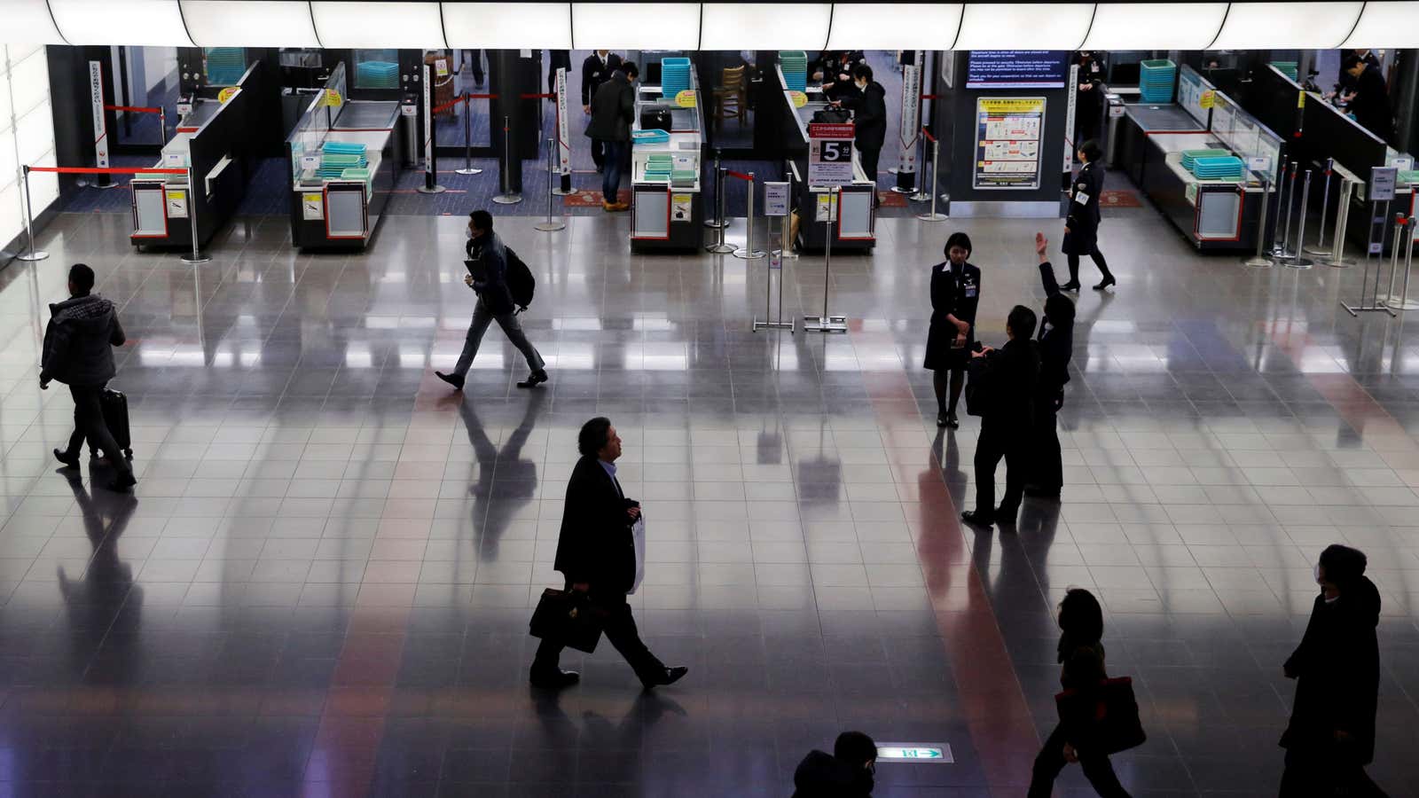Passengers are seen in front of security check at Tokyo’s Haneda Airport.