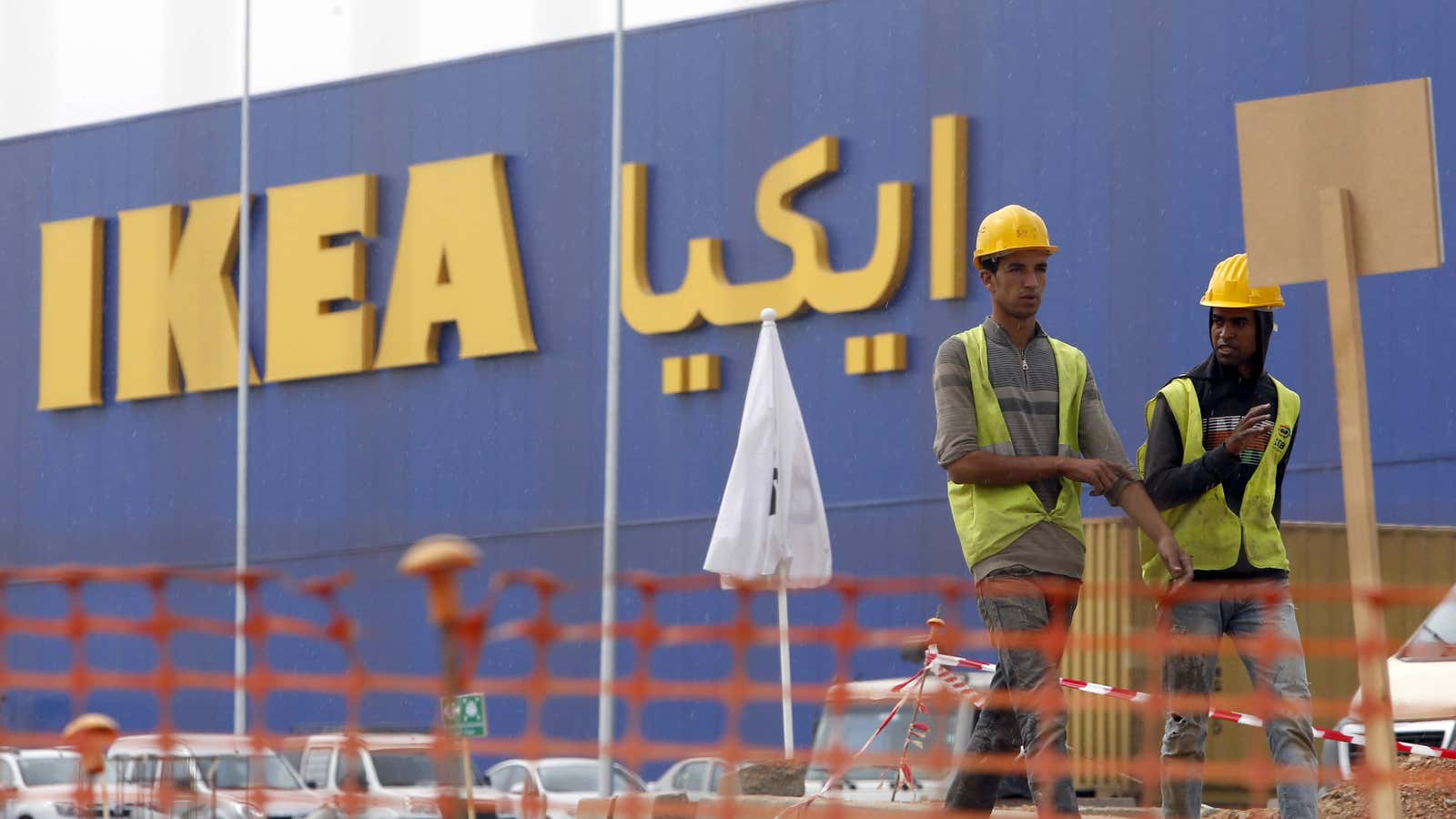 Moroccan workers walk past the construction site of the country’s first IKEA store outside Casablanca, Morocco.