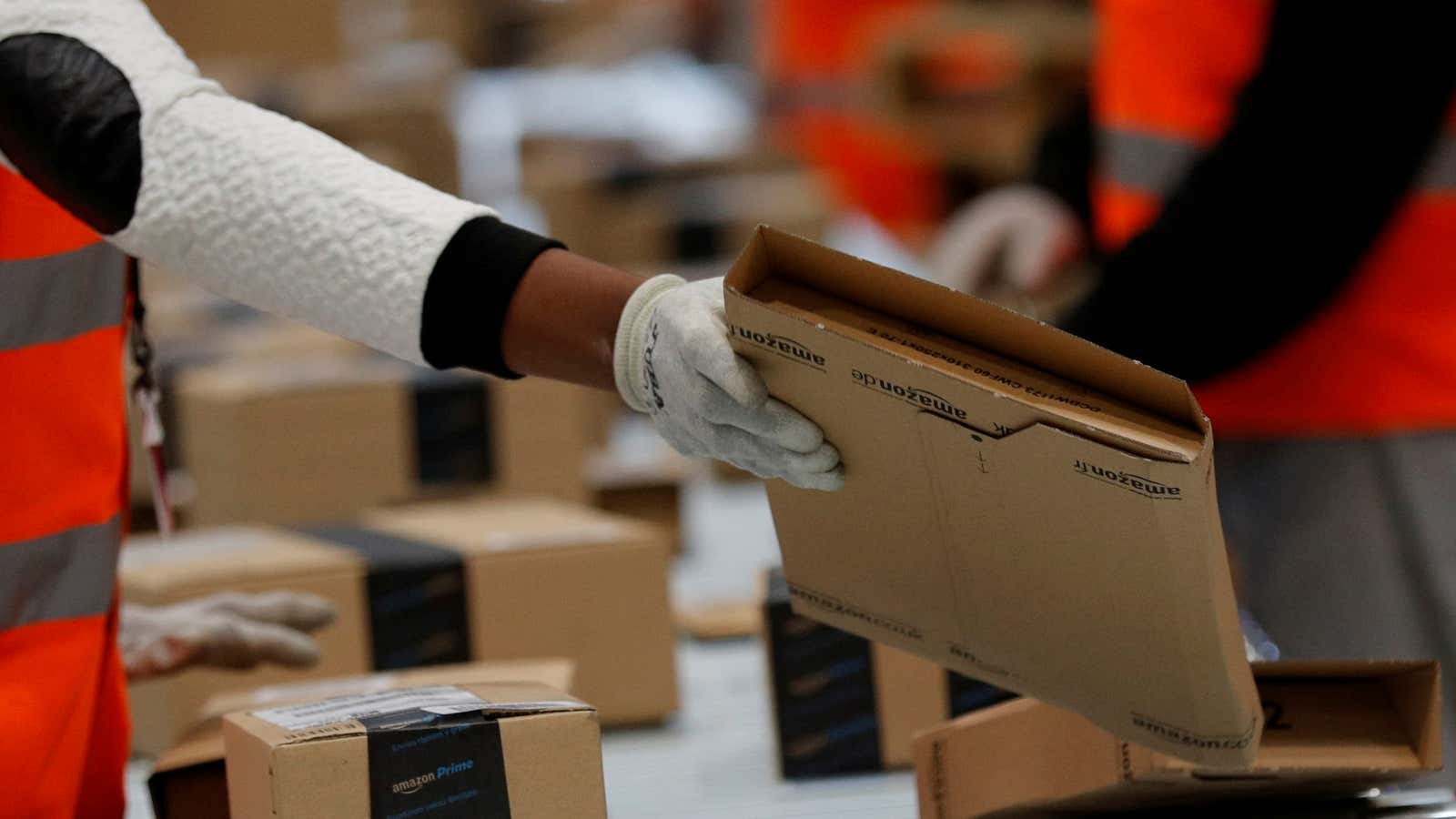 FILE PHOTO: Employees sort packages at the Amazon distribution center warehouse in Saran, near Orleans, France, November 22, 2016. REUTERS/Philippe Wojazer/File Photo – RC1A752F3A30