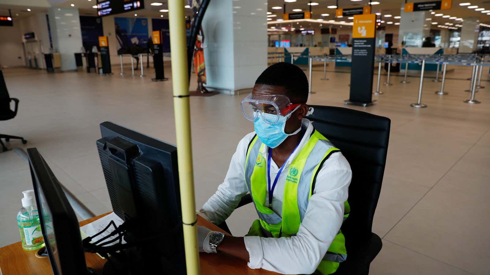 A health worker monitors a screen showing a thermal scan to check the temperatures of passengers at the Kotoka International Airport in Accra, Ghana