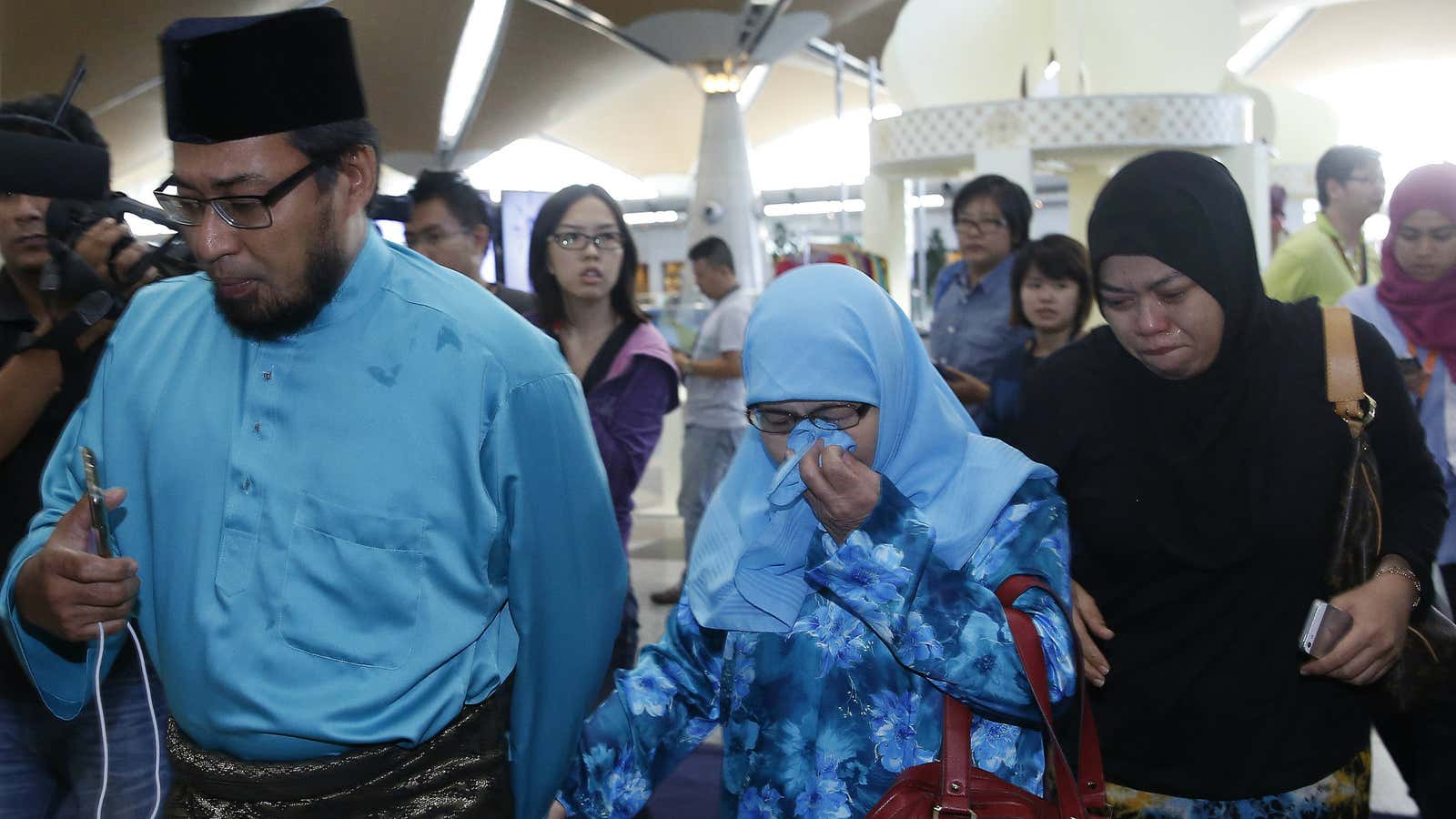 Relatives of passengers aboard the downed flight from Amsterdam arrive in Kuala Lumpur.