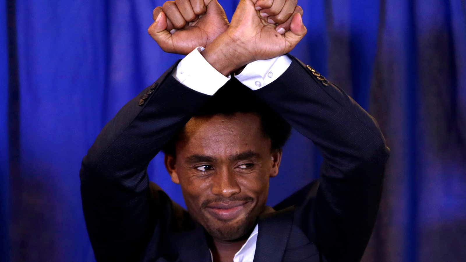 Feyisa Lilesa of Ethiopia arrives at a news conference in Washington.