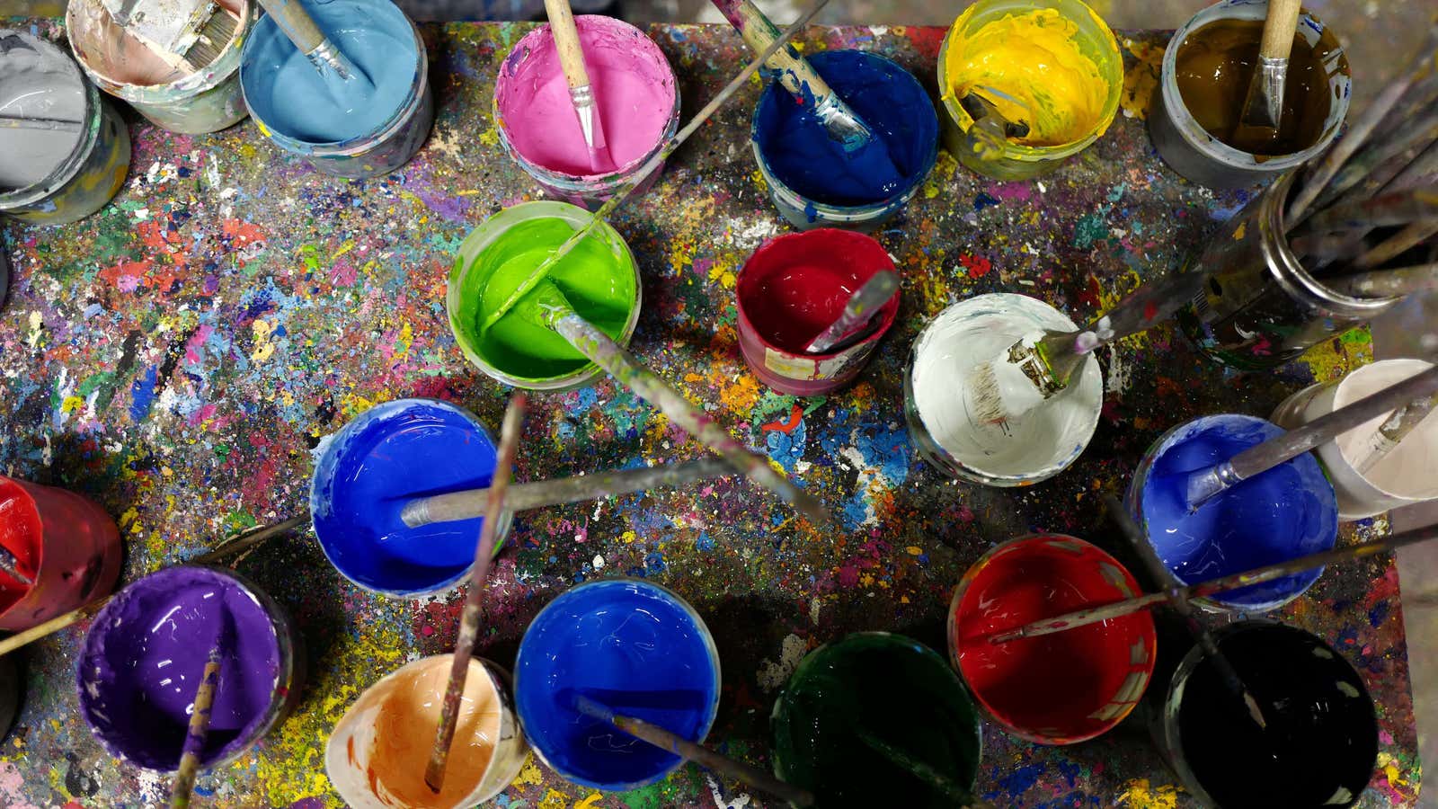 Paint in different colors are seen on a table at an art class for children in the city of Hanau near Frankfurt, Germany, March 7,…