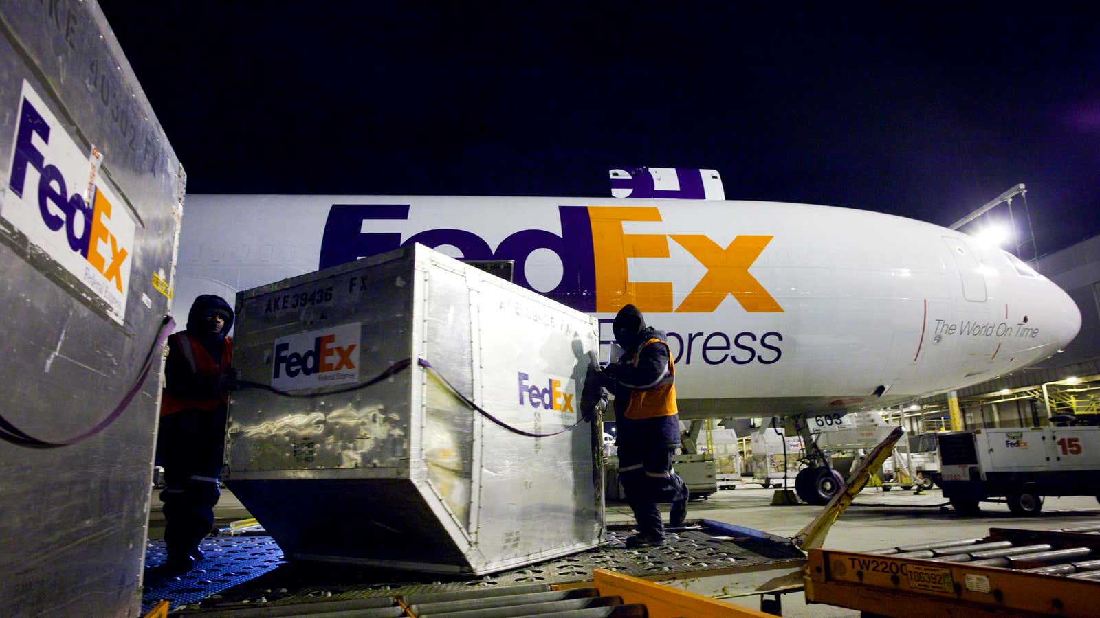 FedEx workers unload one of the company’s cargo planes last year; this year, the firm’s fortunes were bolstered by Apple’s newest iPhone.