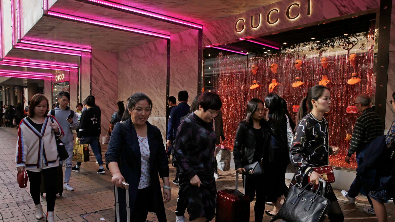 In this Thursday, Nov. 29, 2018, photo, Chinese tourists walk on the Canton Road, the one-stop-shop high street of high-end brands in Hong Kong. Chinese…