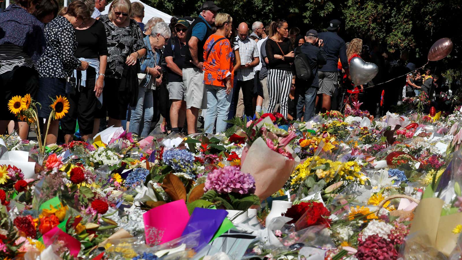 Mourners gather at the memorial site of the Christchurch shooting in New Zealand.