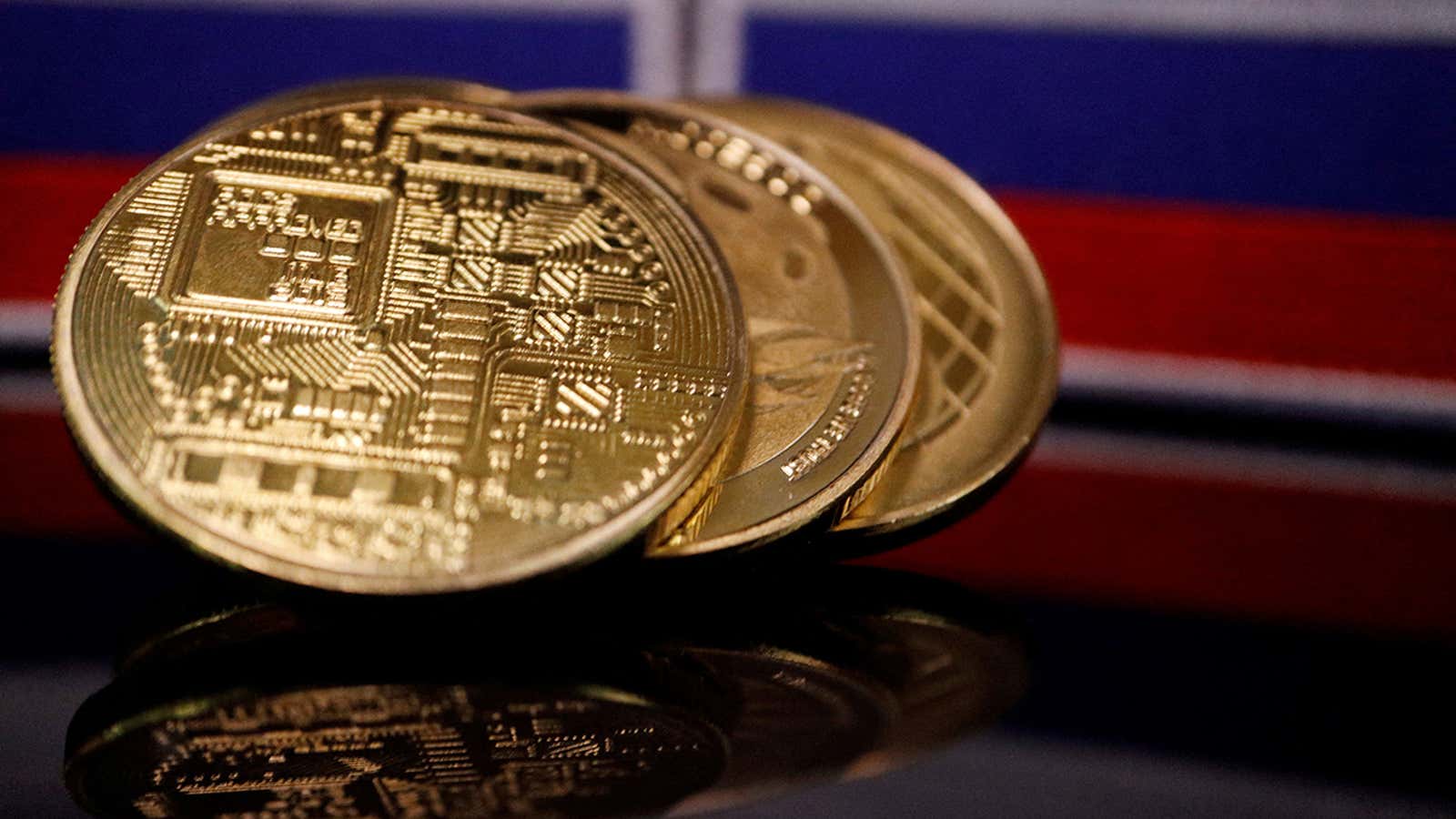 FILE PHOTO: Representations of cryptocurrencies are displayed in front of Russian flags in this picture illustration taken March 4, 2022. REUTERS/Florence Lo/File Photo