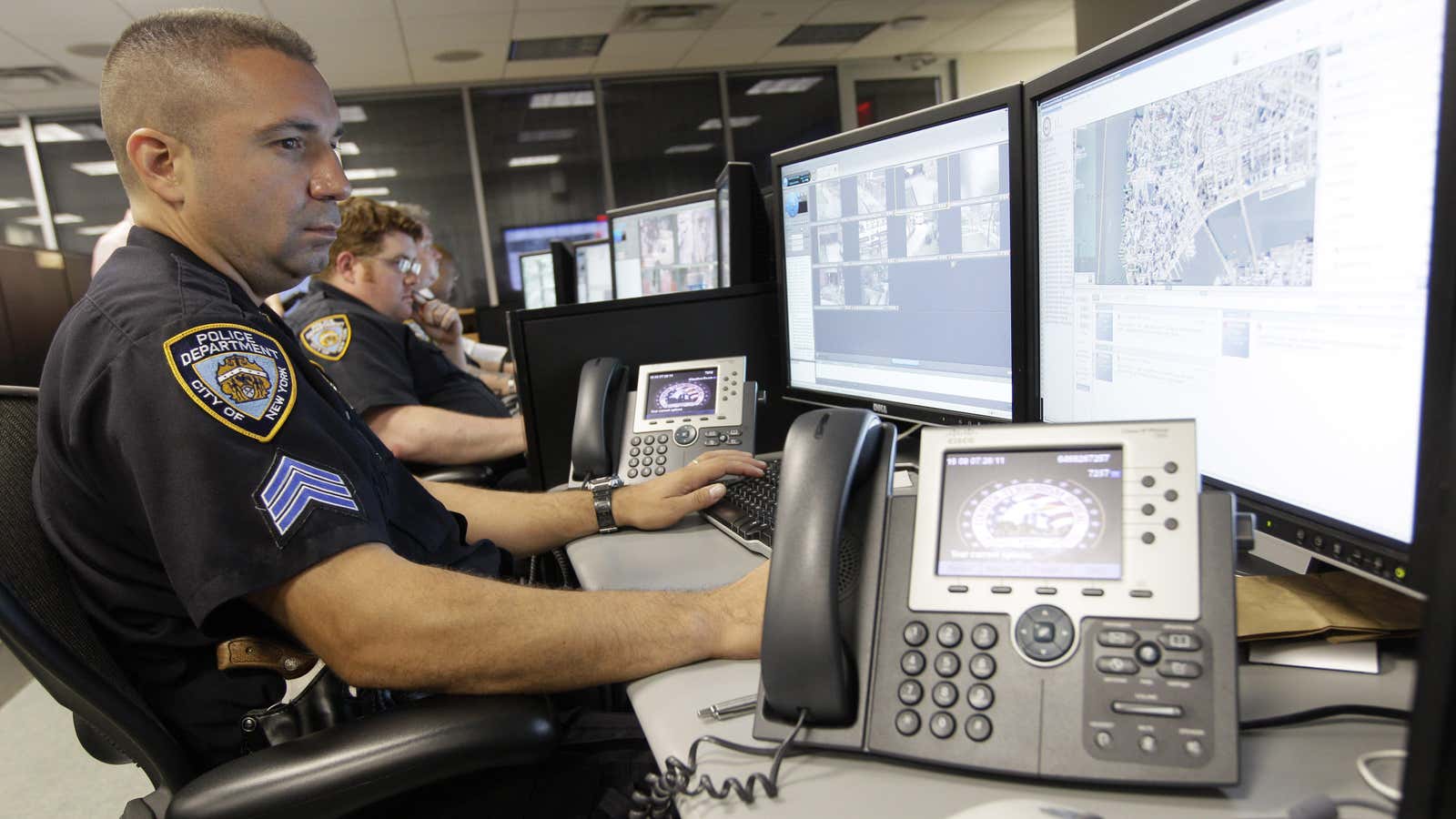 FILE – In this Thursday, July 28, 2011 file photo, police officers look at computer monitors in the operations center of the Lower Manhattan Security…