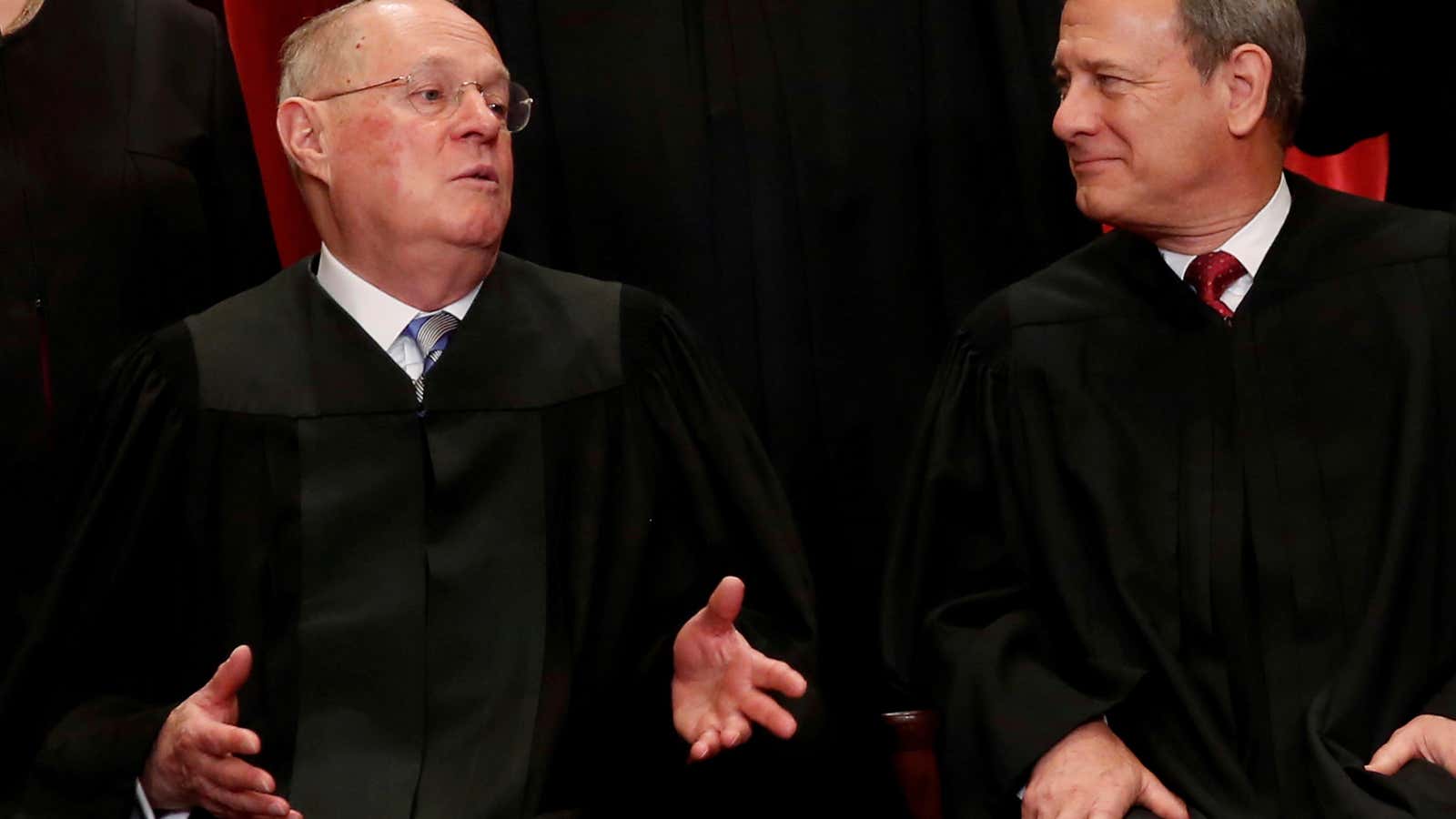 US Supreme Court Justice Anthony Kennedy chats with Chief Justice John Roberts.