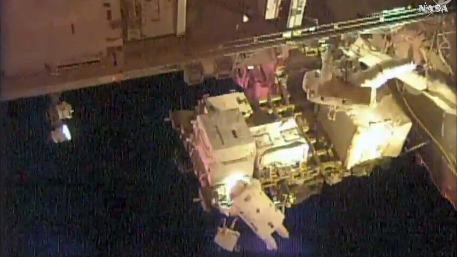 Scott Kelly (upper right) and Kjell Lindgren (bottom) doing maintenance on the International Space Station earlier today.