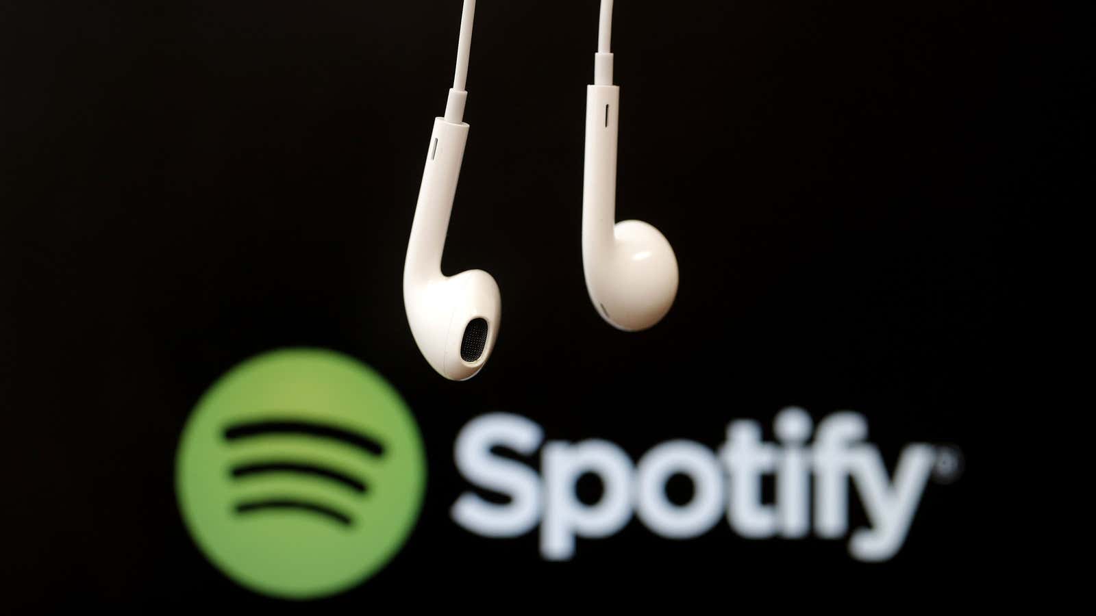Headphones are seen in front of a logo of online music streaming service Spotify in this illustration picture taken in Strasbourg, February 18, 2014. Spotify…