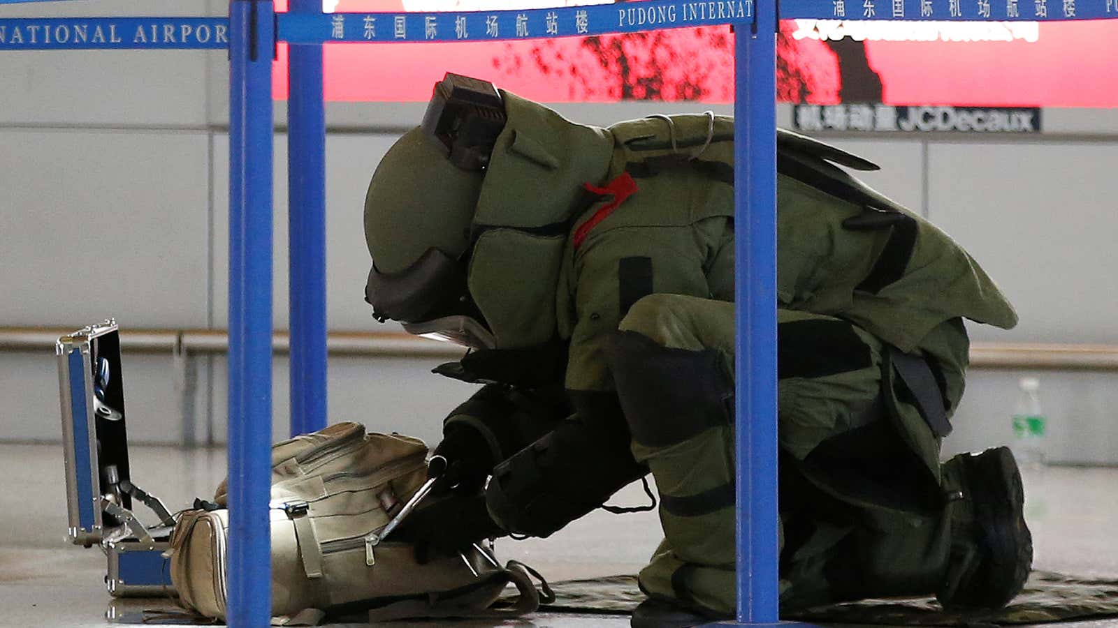 A bomb disposal expert checks a luggage near the site of the blast.