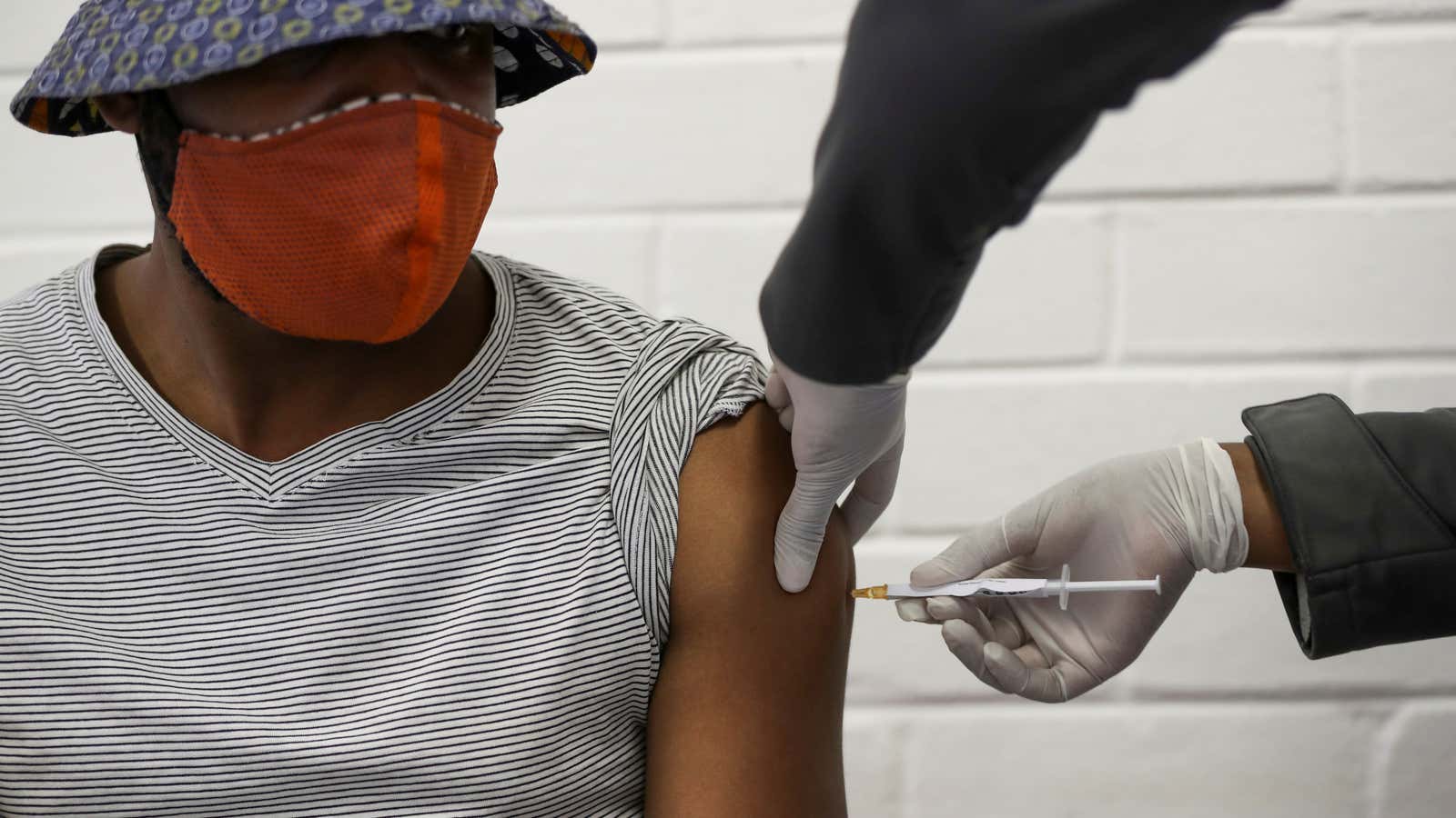A volunteer receives an injection during the South Africa first human clinical trial for a potential vaccine against the novel coronavirus in Soweto, South Africa, June 24, 2020.