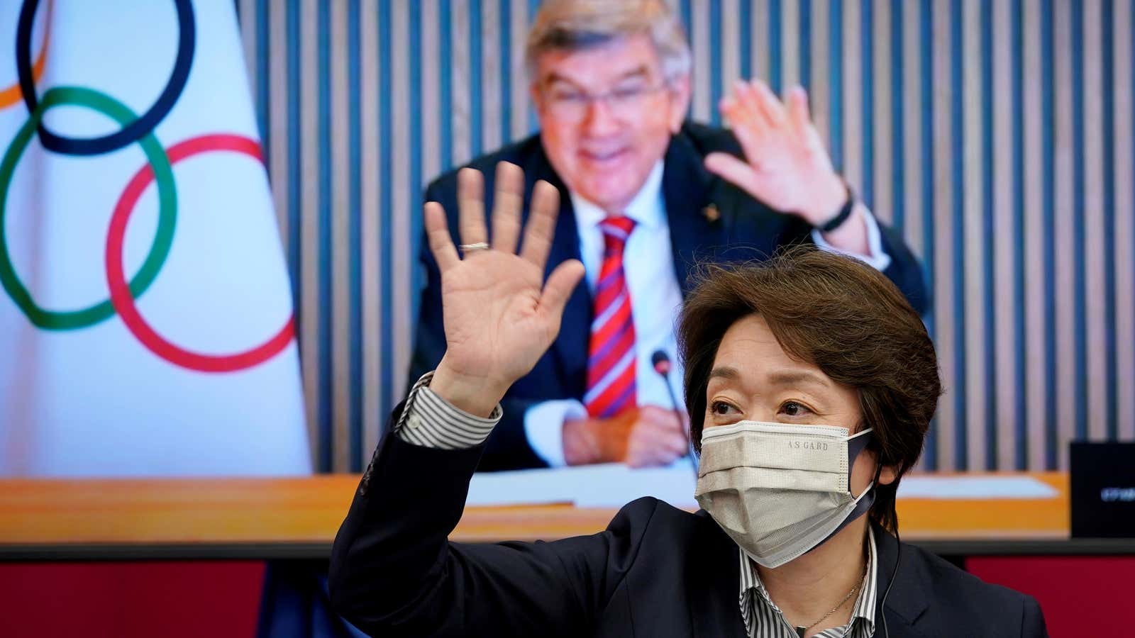 International Olympic Committee (IOC) president Thomas Bach (on a screen) and Tokyo 2020 Organizing Committee president Seiko Hashimoto wave to each other at the startâ€¦