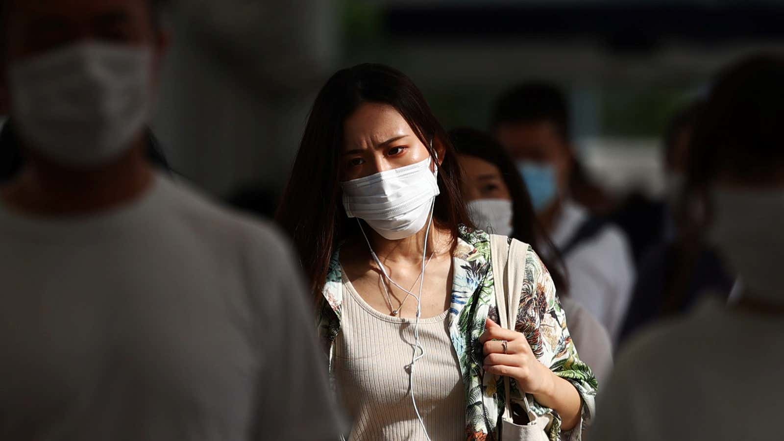 Commuters wearing masks leave a train station during the coronavirus disease (COVID-19) outbreak
