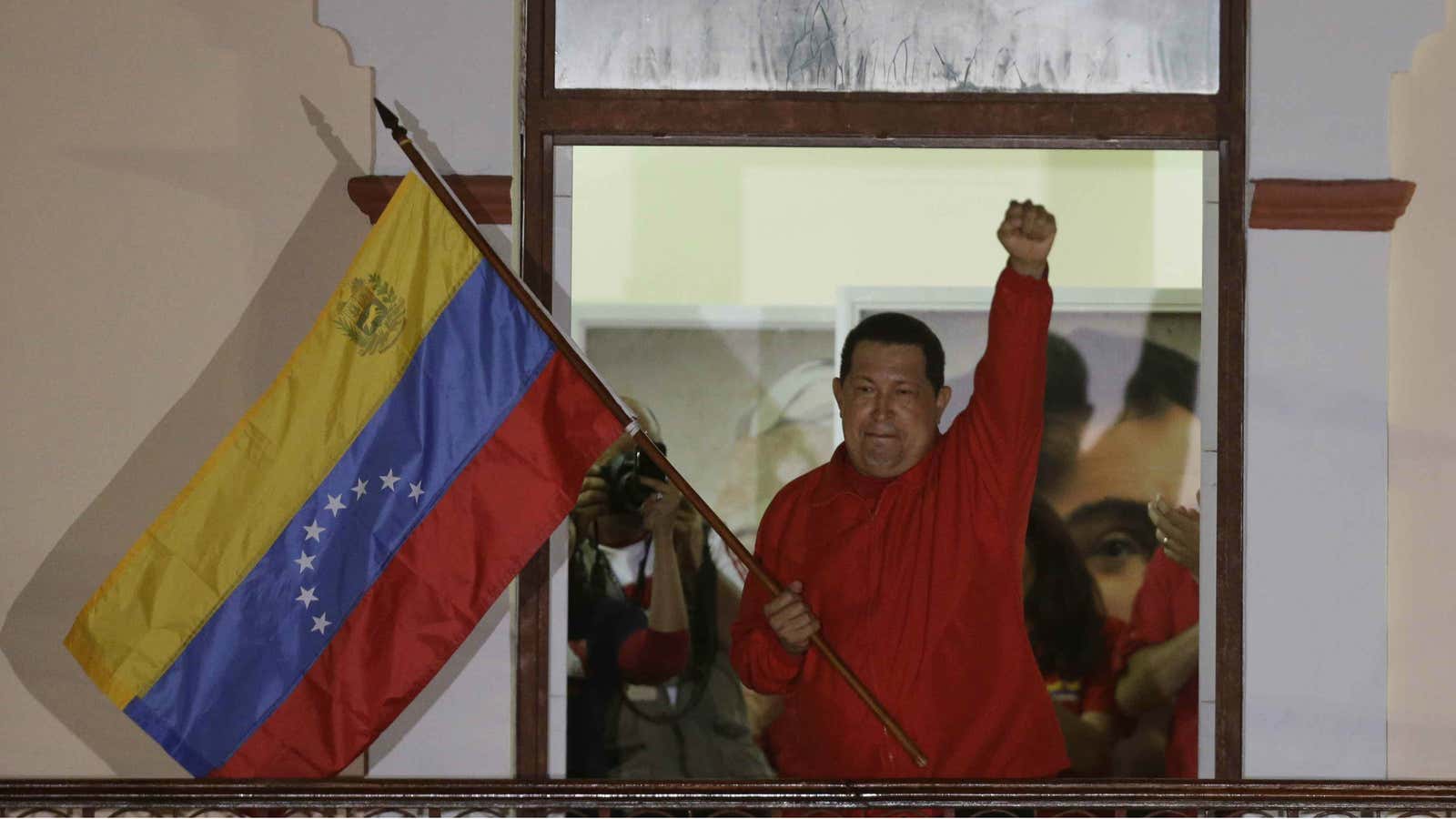 Hugo Chavez waves the flag