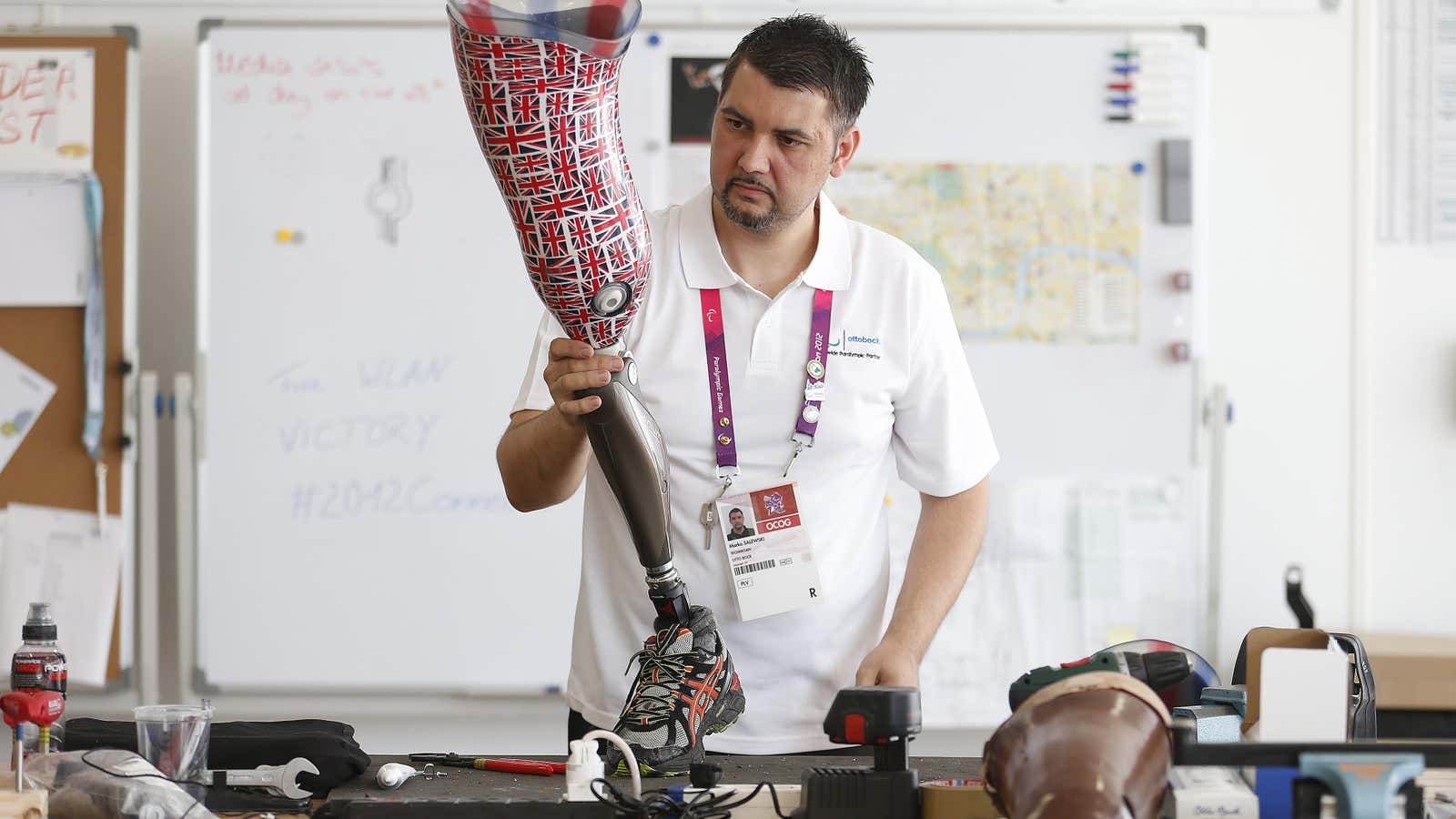 A technician works on a prosthetic leg for Britain’s discus thrower Darren Derenalagi in Ottobock’s workshop at the London Paralympic Games in 2012