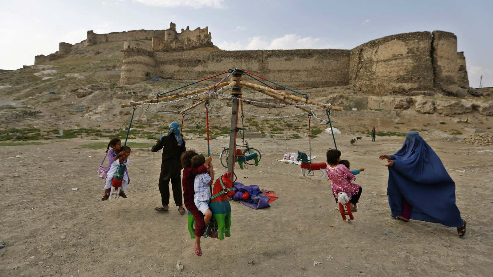 Children play on a carnival ride during Eid al-Fitr Holiday in Kabul July 31, 2014. The Eid al-Fitr festival marks the end of the Muslim holy fasting month of Ramadan.