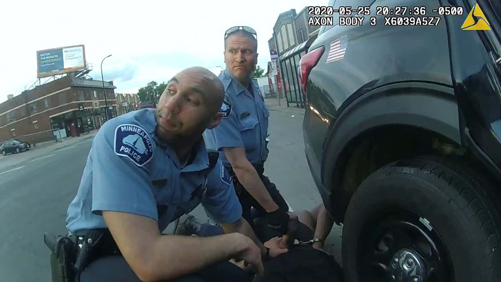 Police body camera footage of former Minneapolis police officer Derek Chauvin (background) kneeling on George Floyd.