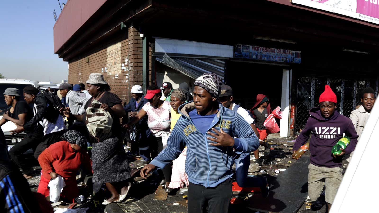 Looters make off with goods from a store in Germiston, east of Johannesburg, South Africa as part of the xenophobic violence against African store owners