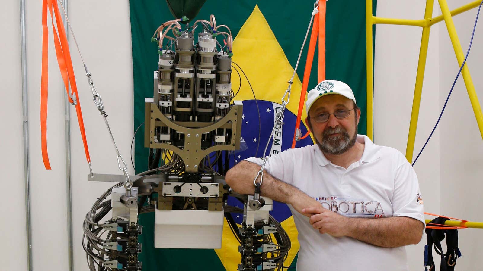 Neuroscientist Miguel Nicolelis with the robotic exoskeleton that will kick off the 2014 World Cup