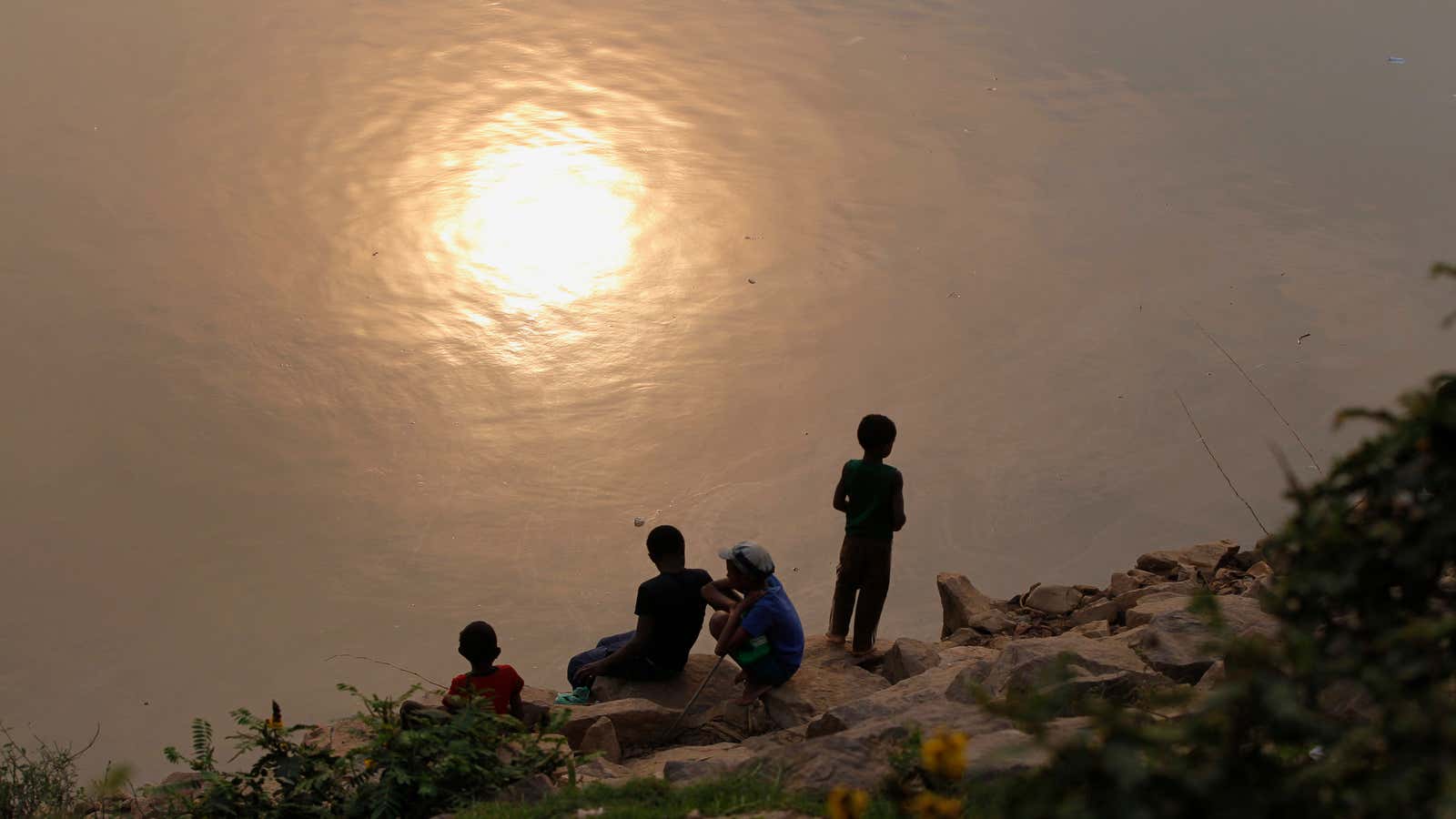 Boys fish along the banks of the Ikopa river in Madagascar’s capital Antananarivo