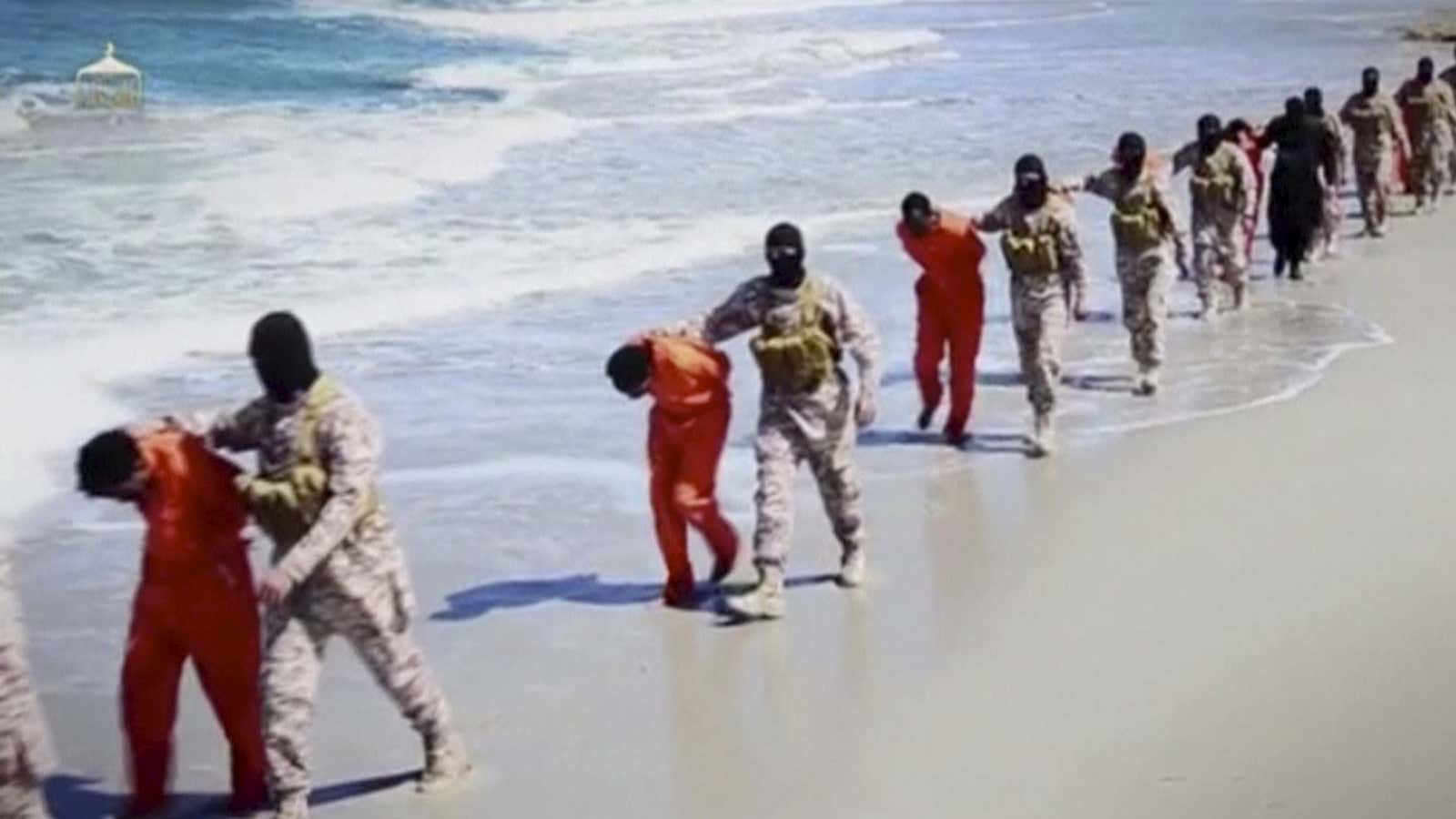 Islamic State militants lead what are said to be Ethiopian Christians along a beach in Wilayat Barqa, in this still image from an undated video made available on a social media website.