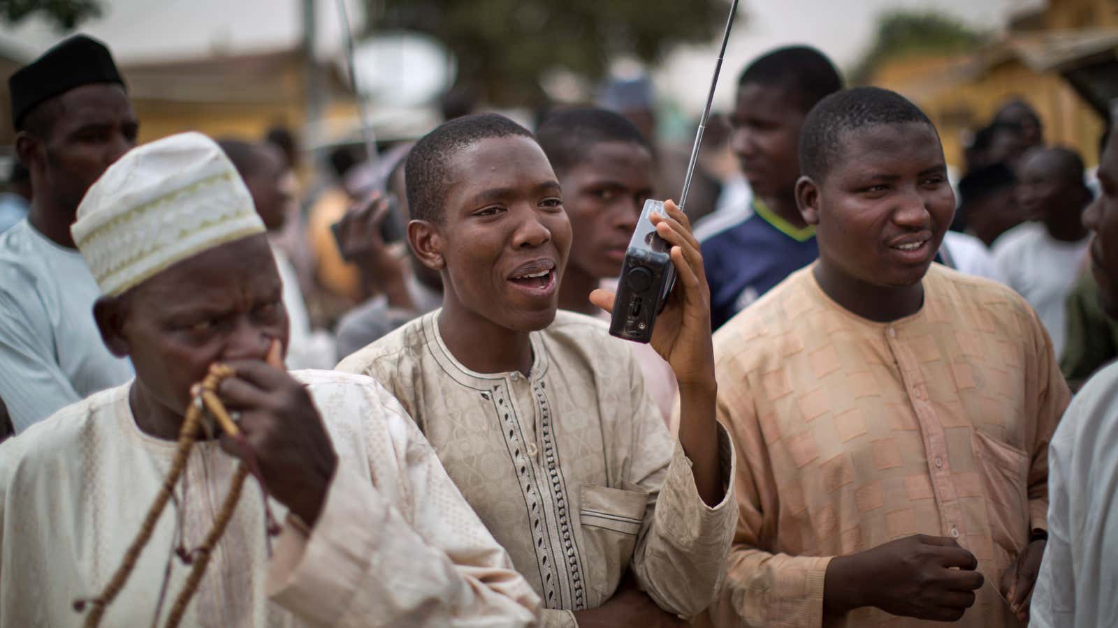 Nigerian men listen to the news on a portable radio in Daura, the northwest home town Muhammadu Buhari,  March 2015.