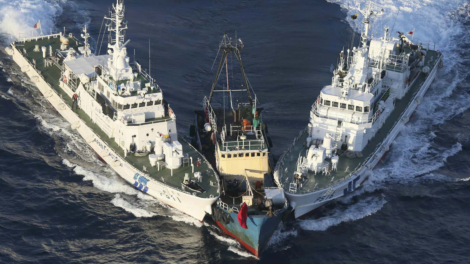 The Japanese coast guard surrounds an offending boat.